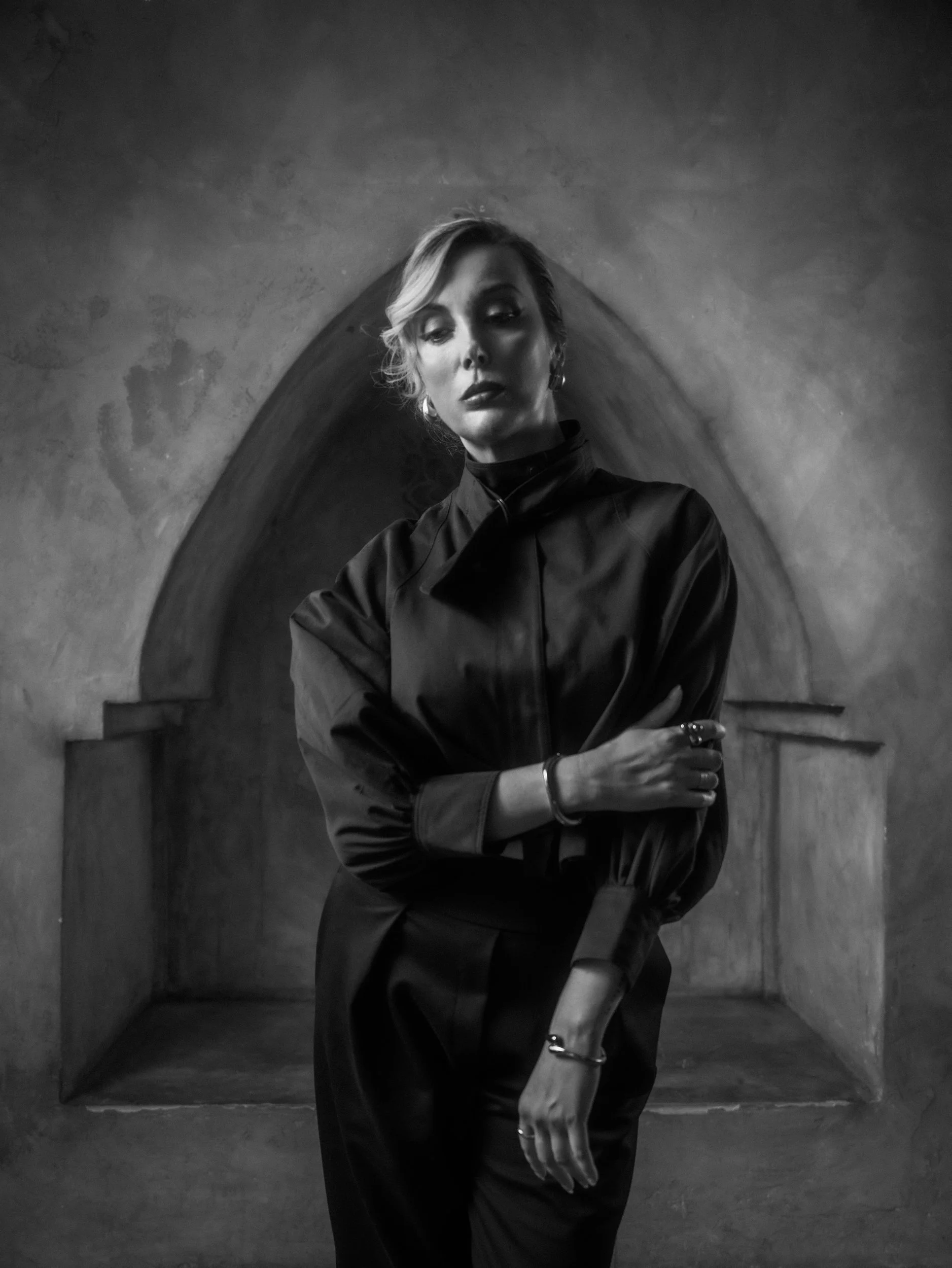 Black and white portrait of Milanka Brooks in a black tie-neck jacket, editorial fashion photography by Osy Ikhile, Los Angeles
