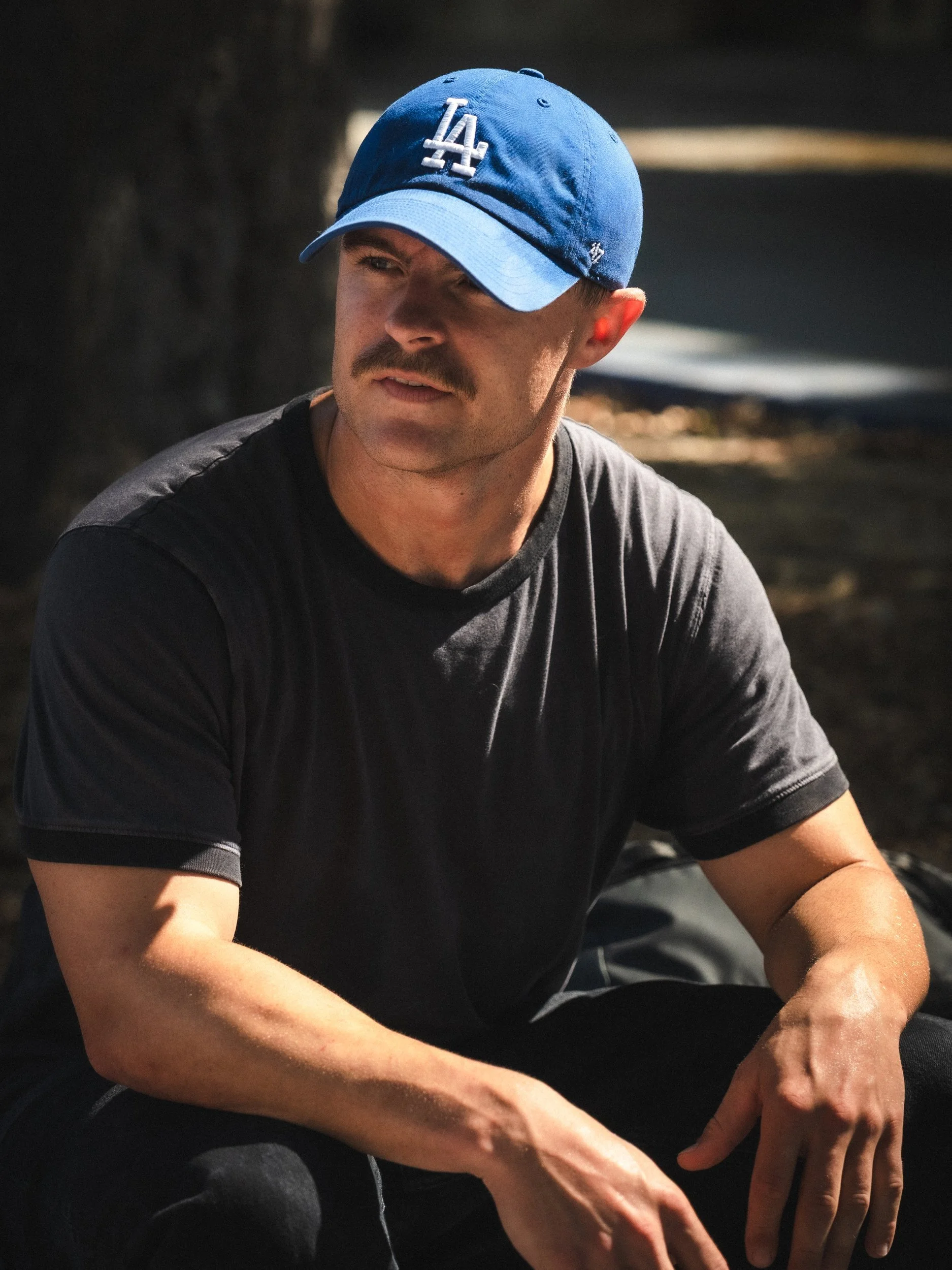 Portrait of Isaiah Rojers in an LA cap at the West LA Courthouse skatepark, Los Angeles skate photography by Osy Ikhile