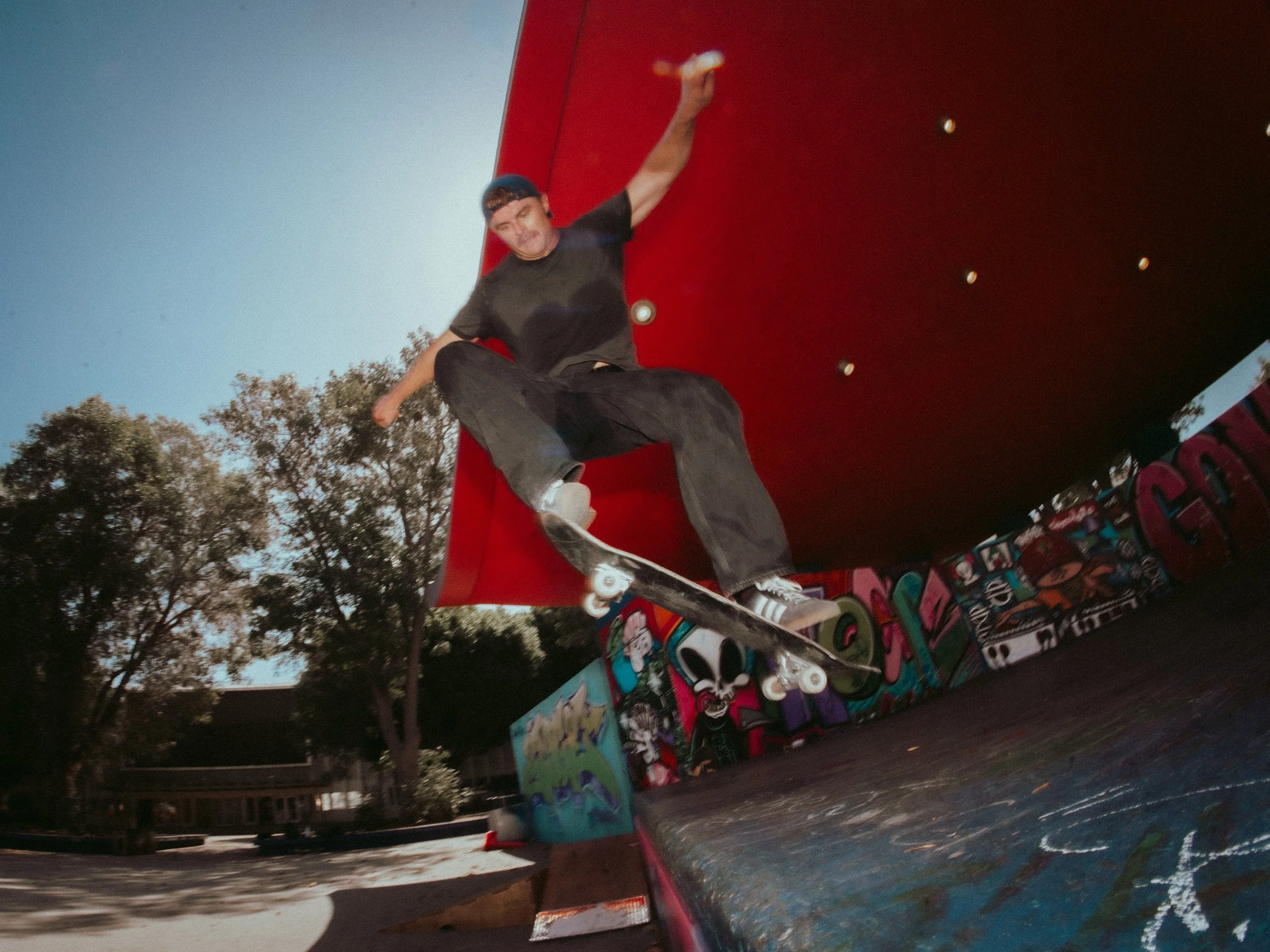 Isaiah Rojers catching air off the red wall at the West LA Courthouse skatepark, Los Angeles skate photography by Osy Ikhile
