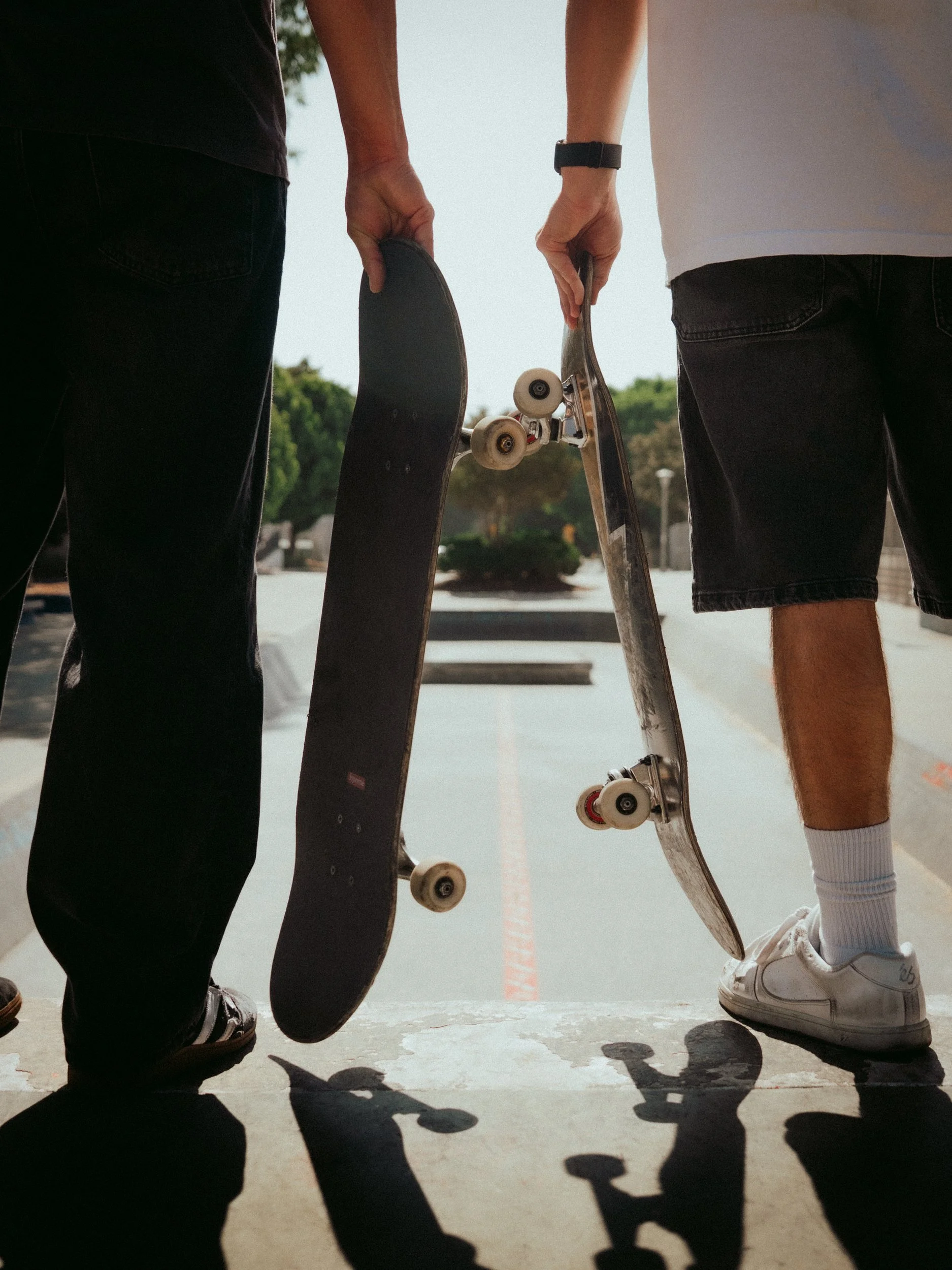 Brandon Loufas and Isaiah Rojers holding their boards at the West LA Courthouse skatepark, Los Angeles skate photography by Osy Ikhile