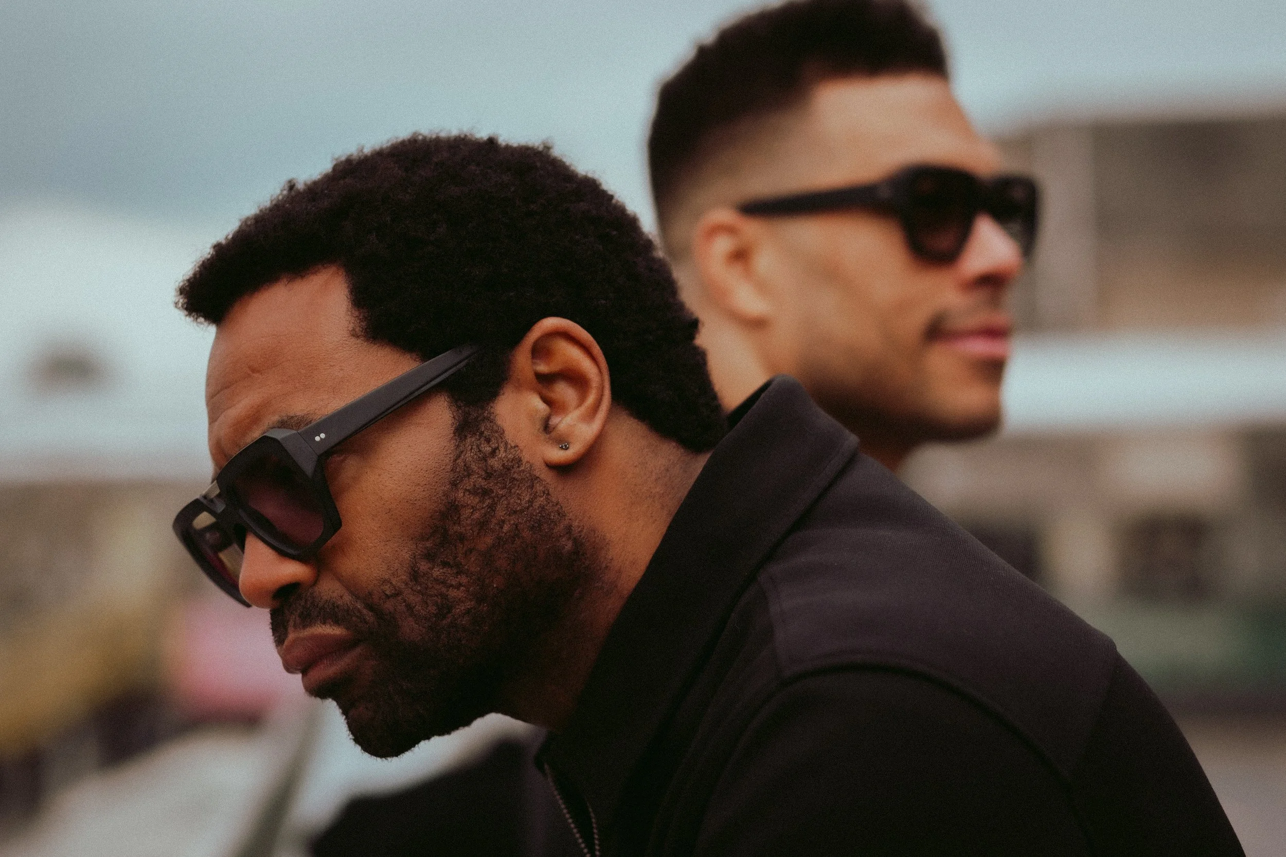 Two men in Kirk & Kirk sunglasses outdoors, lifestyle eyewear campaign