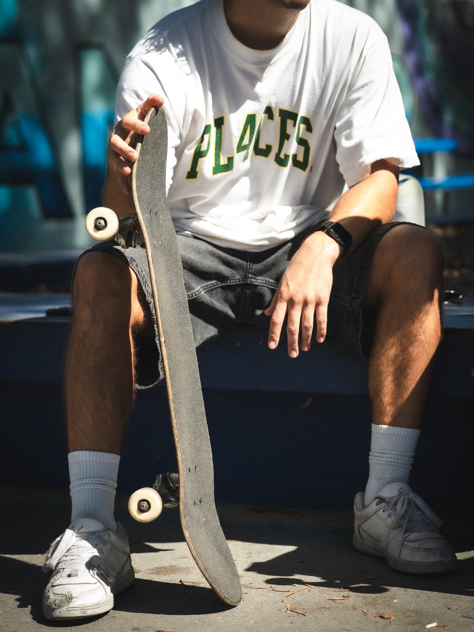 Brandon Loufas with his deck, streetwear skate portrait at the West LA Courthouse skatepark, Los Angeles skate photography by Osy Ikhile