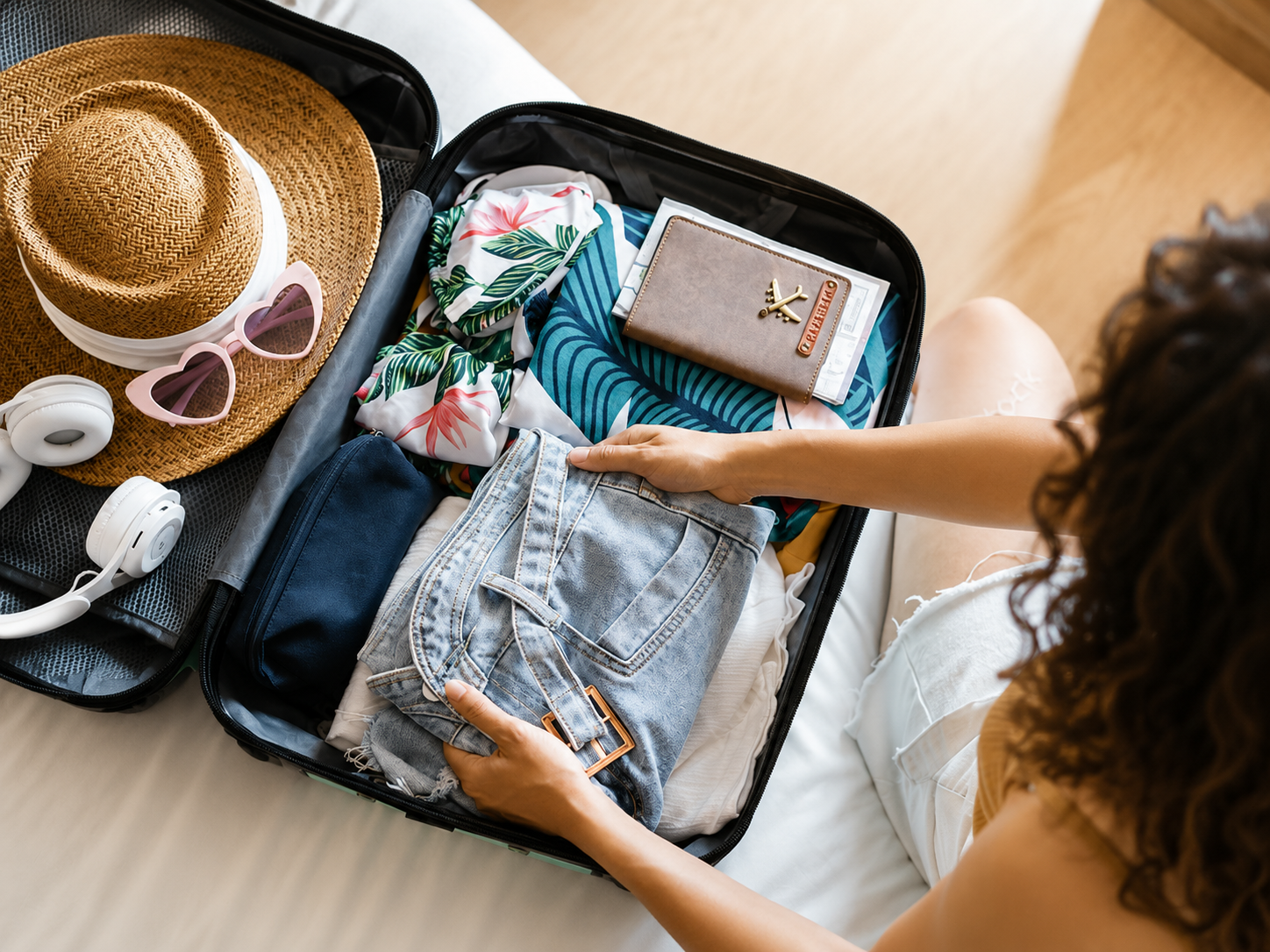 Packing travel essentials for bipolar disorder, including comfort items, headphones, and organized clothing for a stable and stress-free trip.