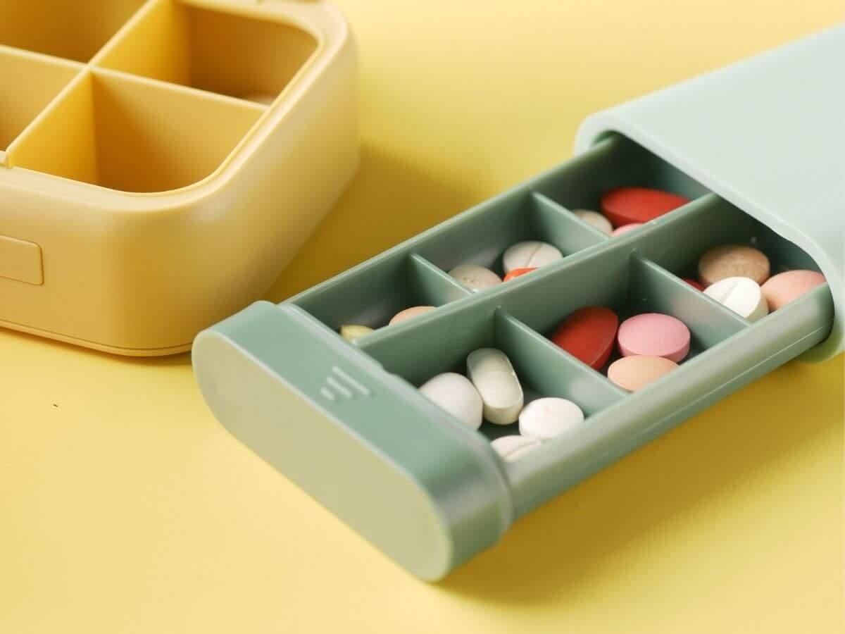 Weekly pill organizer filled with medication, representing treatment options for bipolar disorder.