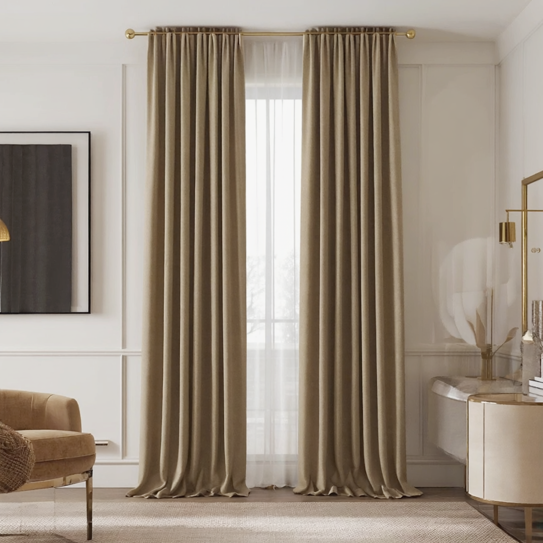 Window with beige drapery and sheer white curtains in living room