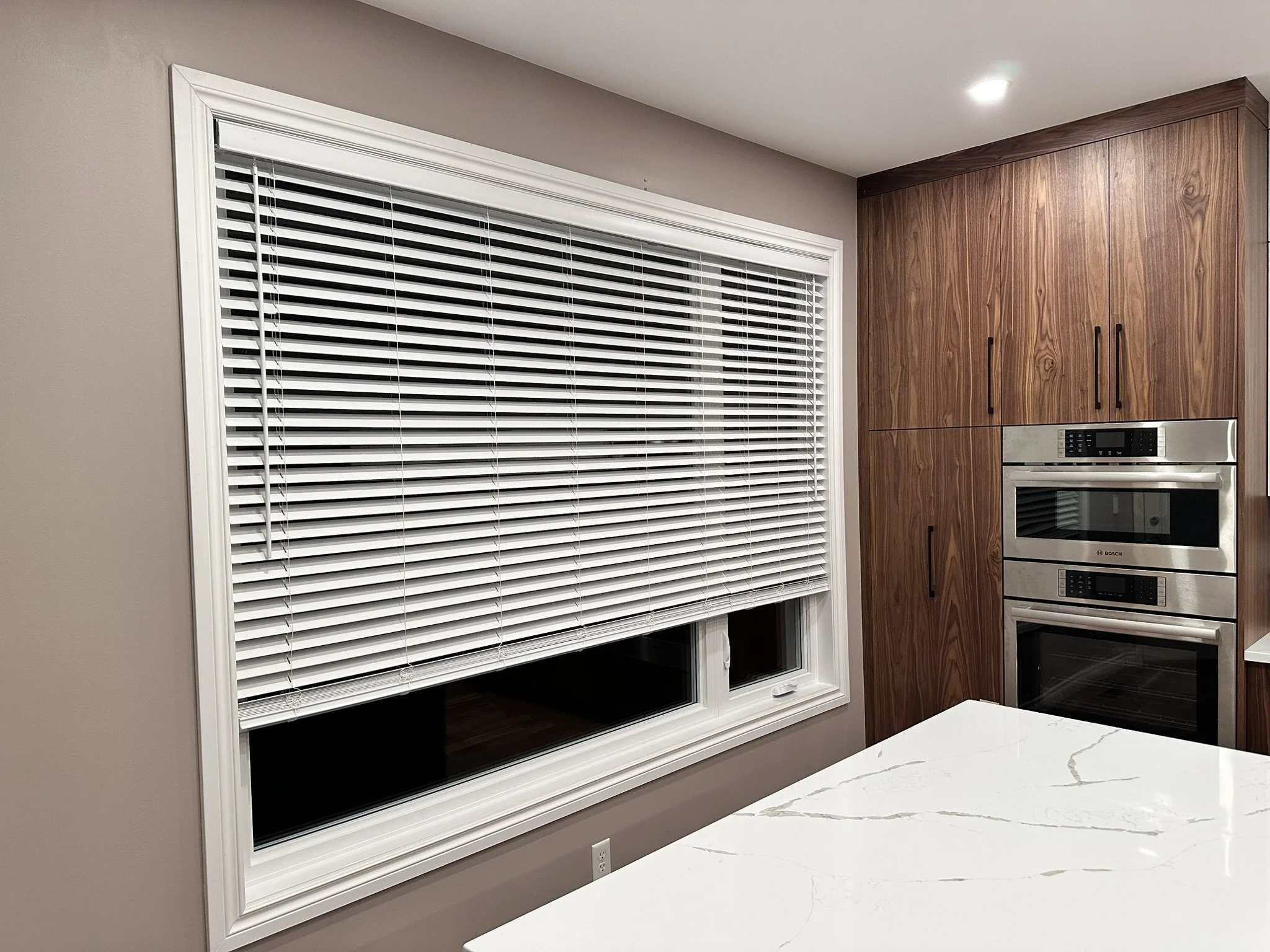 Wide Faux Wood Blinds installed in kitchen