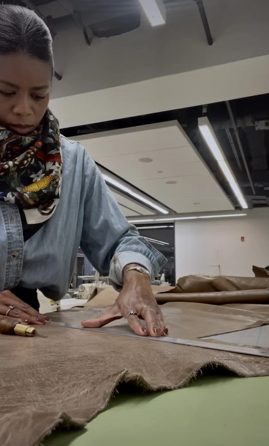 Cutting leather for the tote bag in the handbag design studio at the Fashion Institute of Technology.