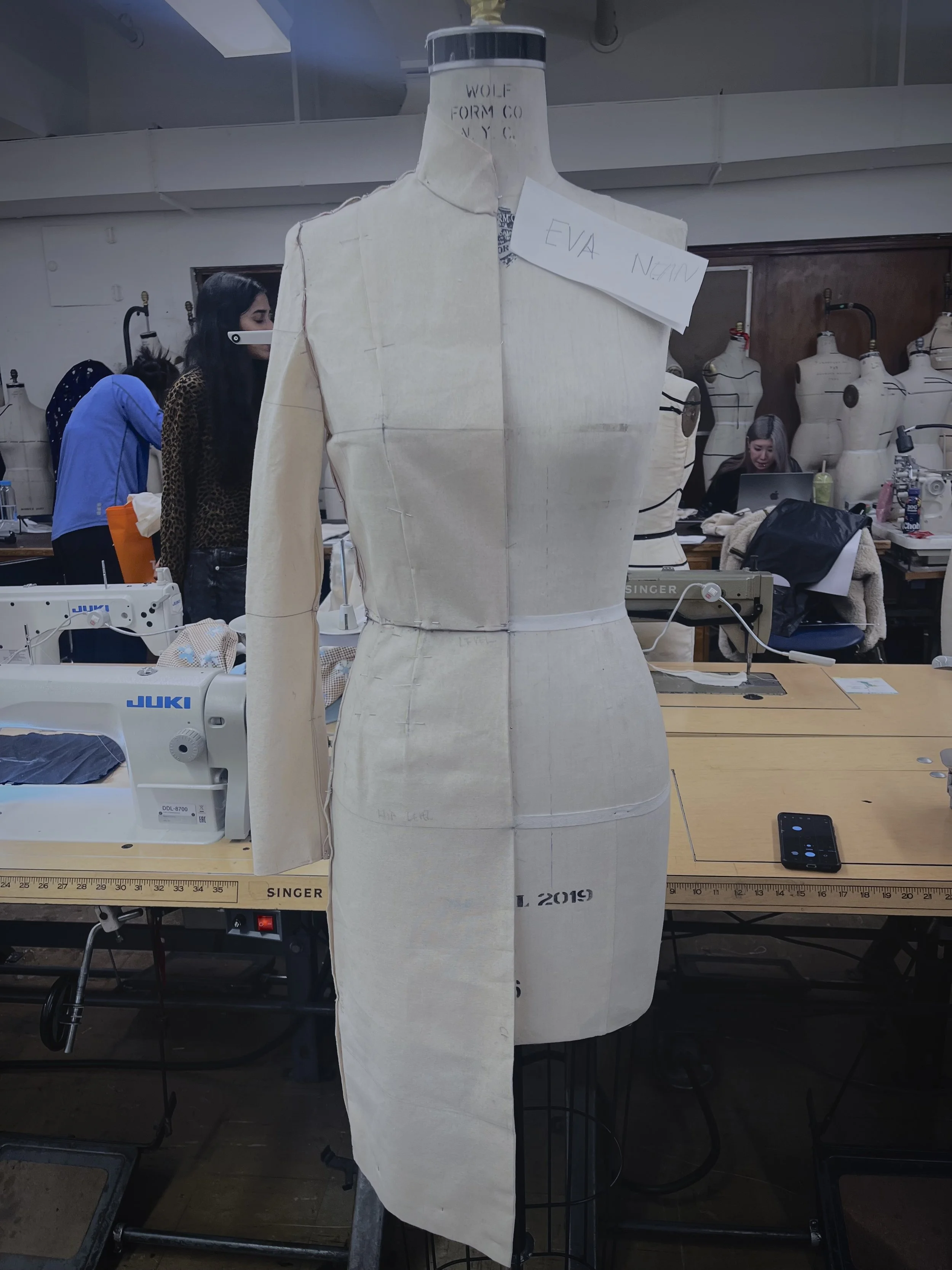 Muslin bodice and skirt fitted on a dress form in a patternmaking classroom at the Fashion Institute of Technology