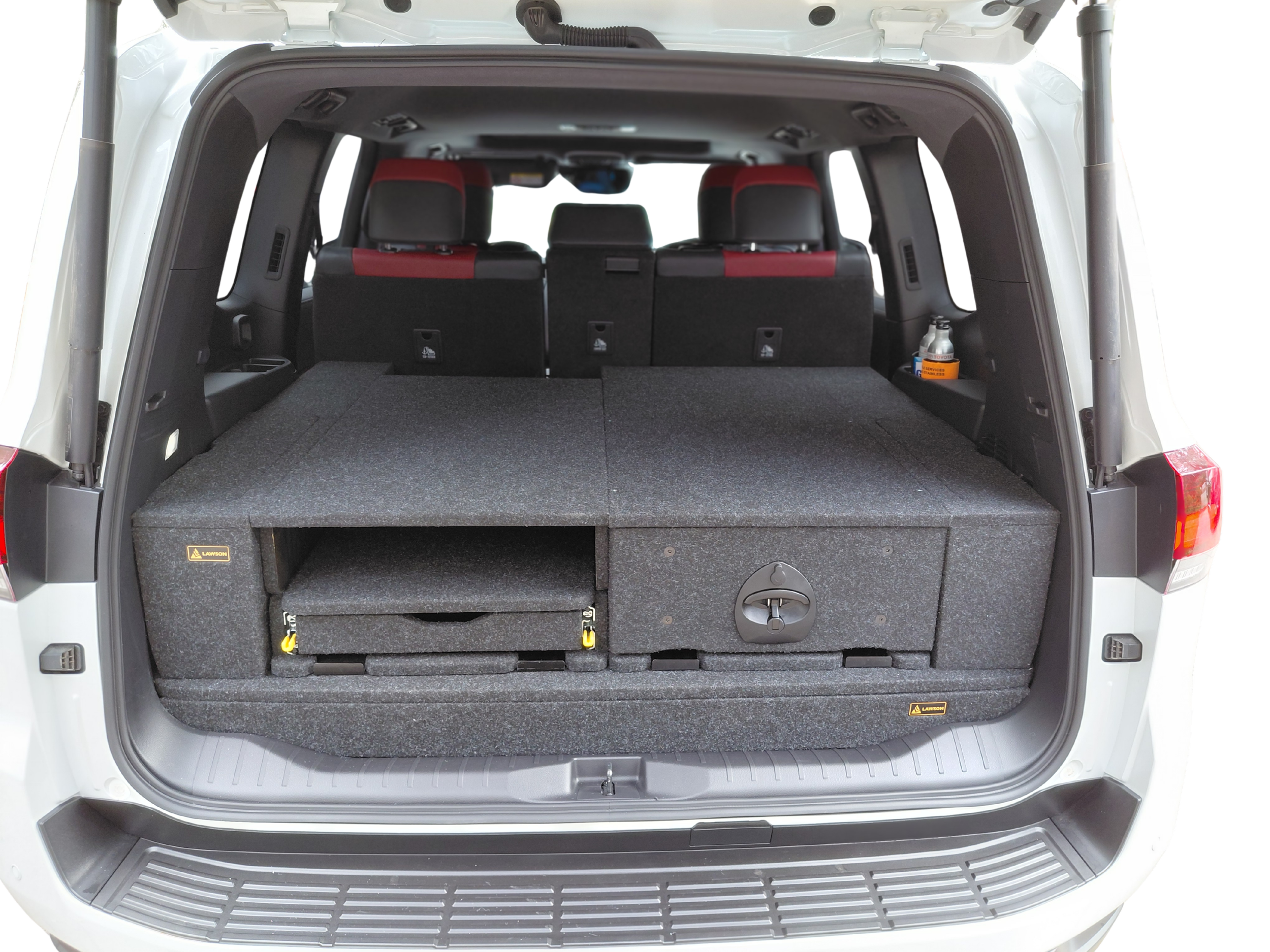 LandCruiser 300 false floor with drawer open and fridge slide extended — mid-side view