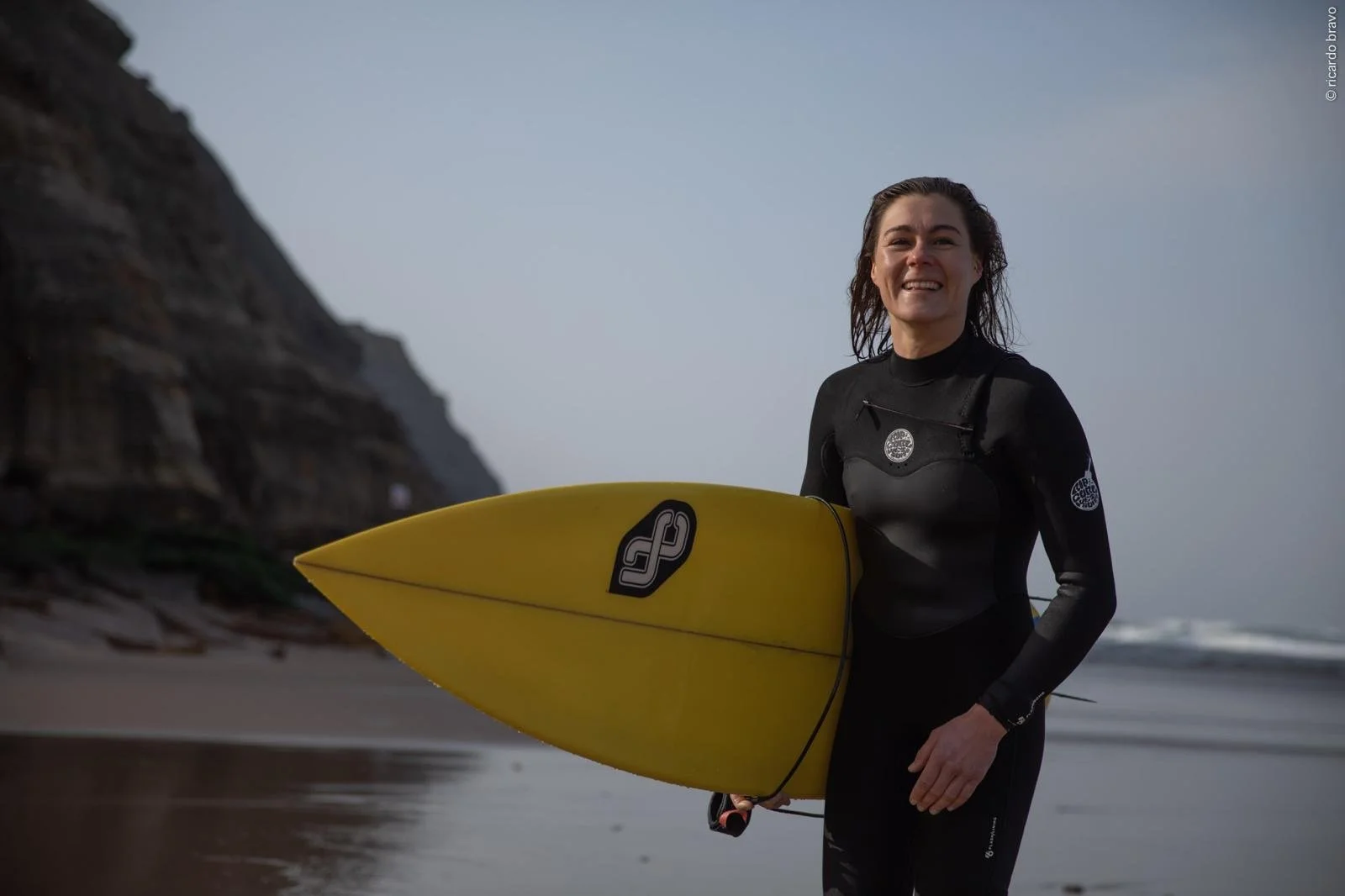 Surf instructor teaching women at surf retreat in Portugal