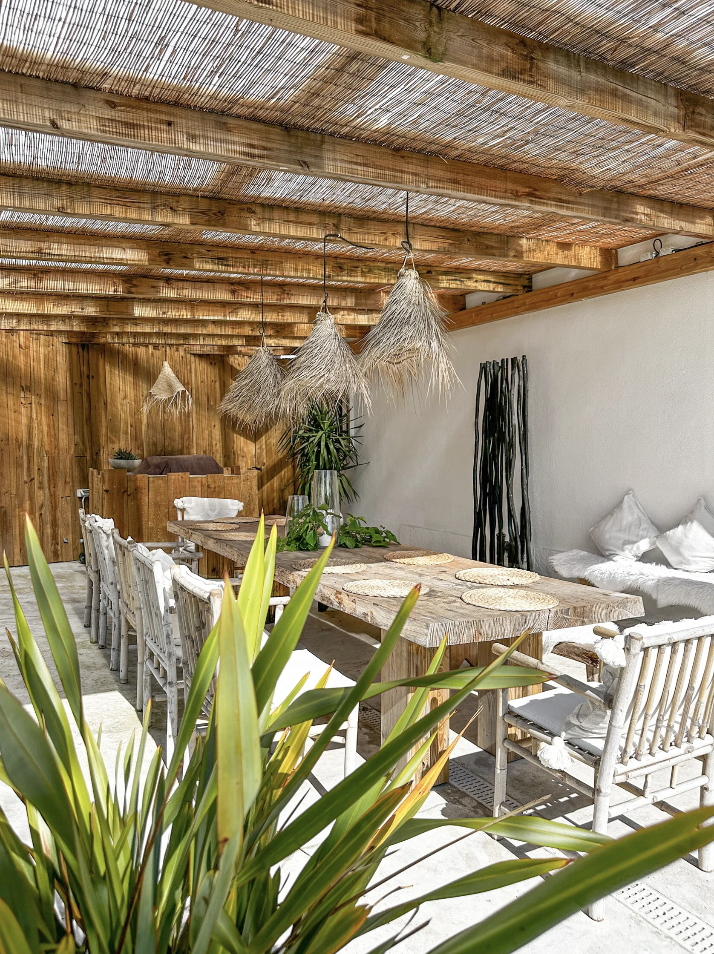 Outdoor dining area with stylish accommodation for surf retreat guests