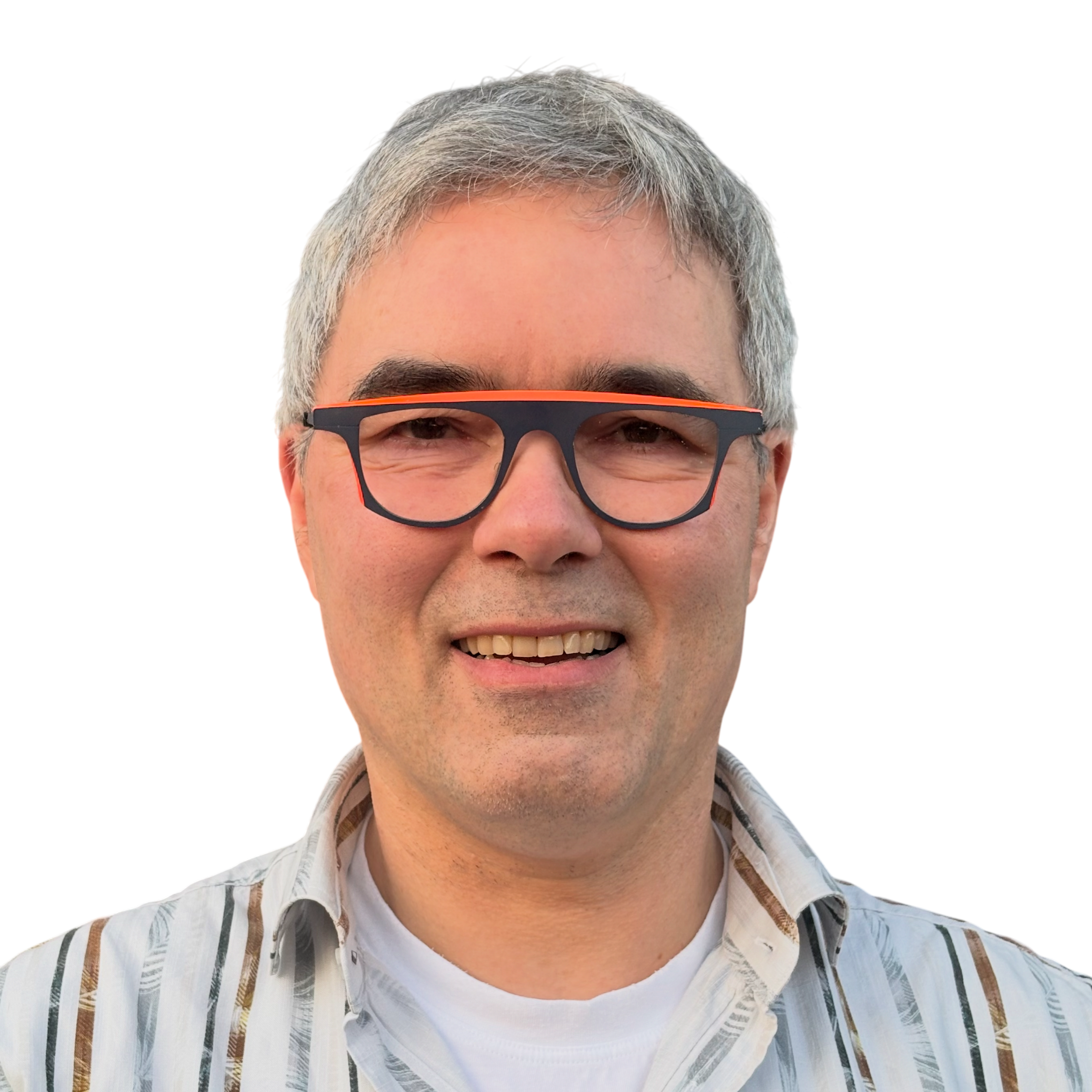 A man with gray hair and glasses smiling, wearing a striped shirt over a white T-shirt.