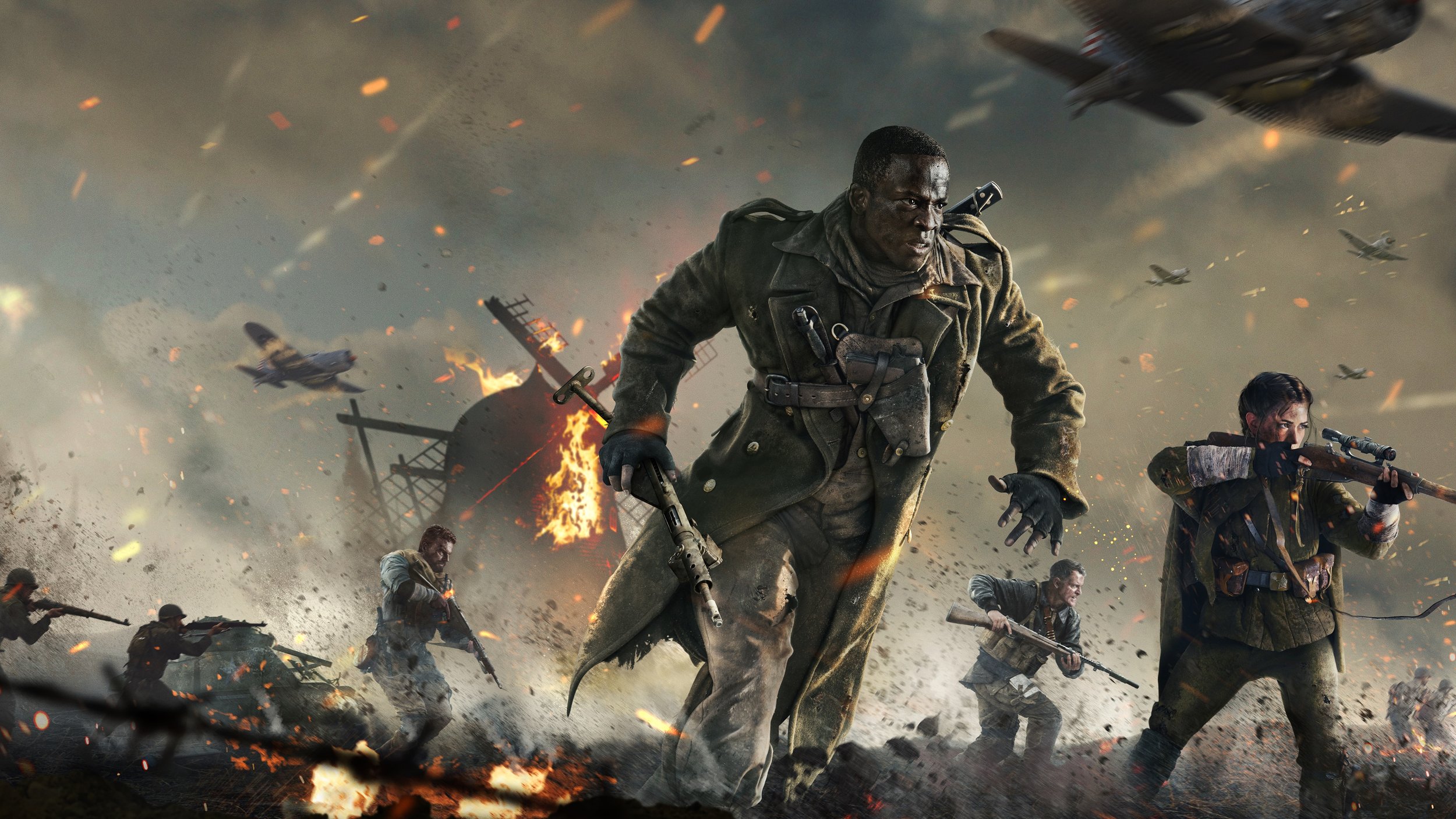 A war scene depicting soldiers fighting amidst explosions and aircraft in the sky, with flames and debris on the ground.