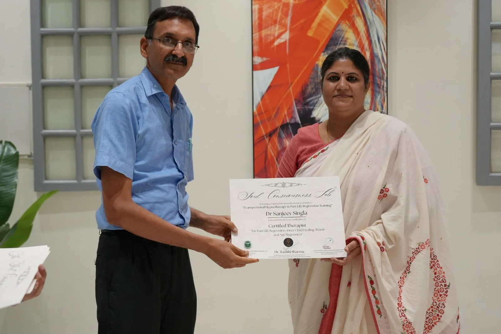 Dr Rashhi Sahrma handling over PLR certificate to student