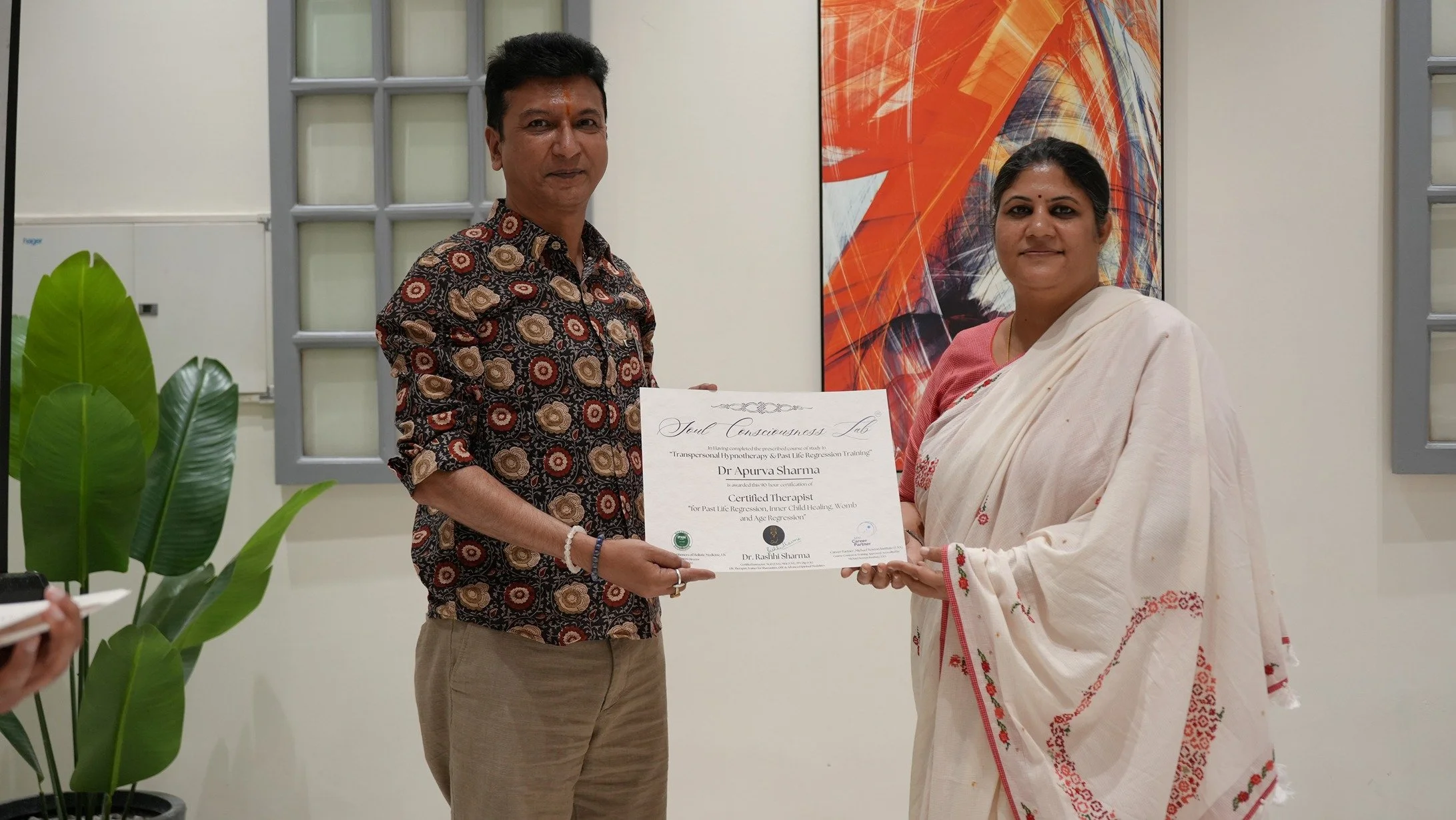 Dr Rashhi Sharma is giving the PLR training practitioner certificate to Dr Apurva.