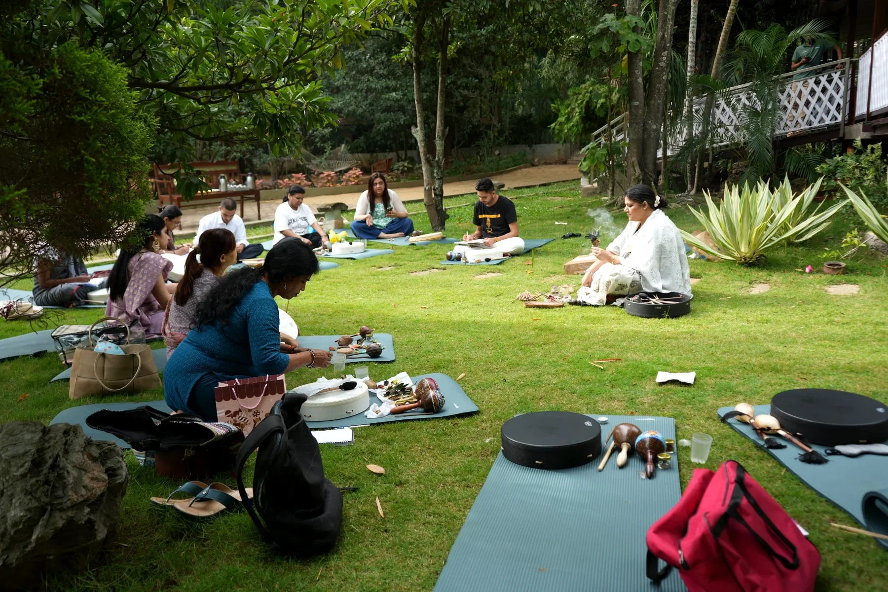A facilitator leading an outdoor shamanism learning session with students seated on mats at Soul Consciousness Lab.