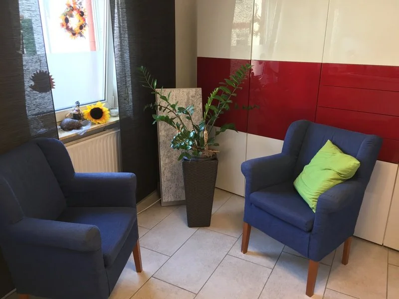 Gesprächsraum der Praxis in Mainz-Hechtsheim mit zwei blauen Sesseln für Gesprächstherapie, psychotherapeutische Begleitung und Coaching.