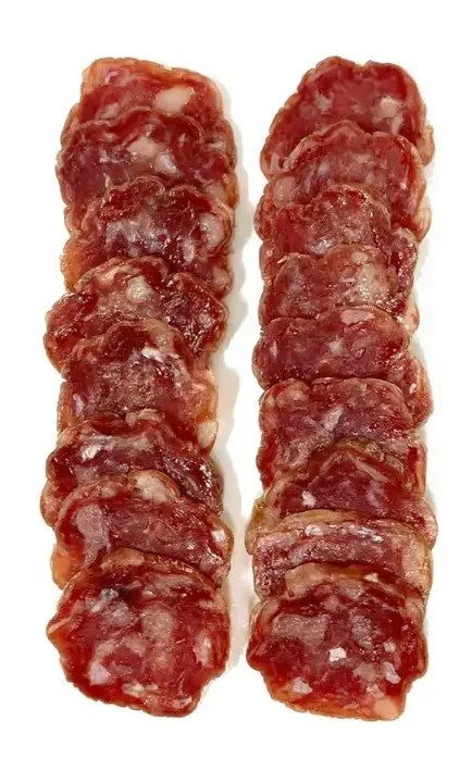 Two skewers of raw meat chunks, likely beef, arranged vertically.
