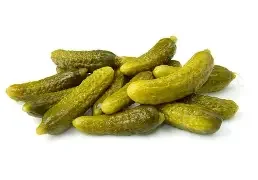 A pile of pickles on a white background.