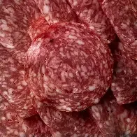 Close-up of sliced salami with a marbled appearance.