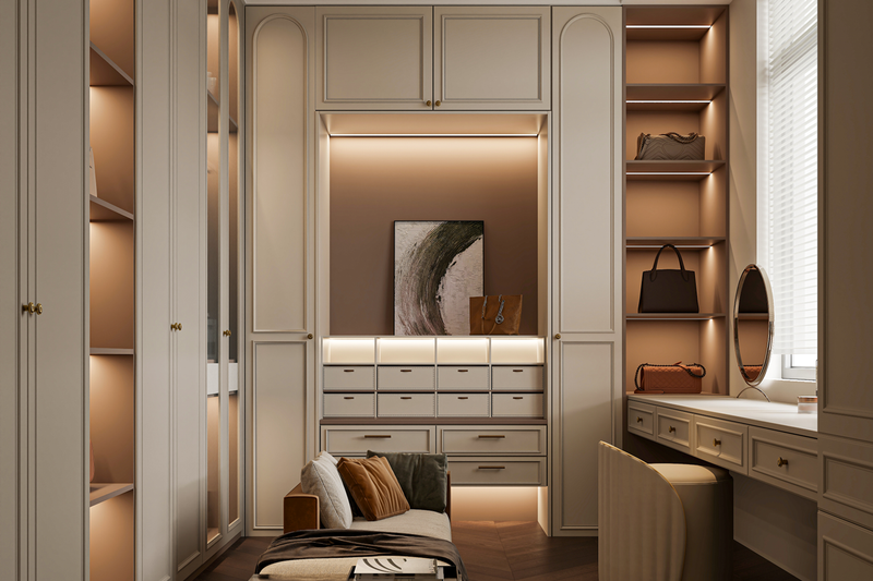 Luxurious walk-in closet with built-in cabinetry, shelves, and drawers, illuminated with warm lighting, featuring handbags, decorative art, and a cozy seating area.