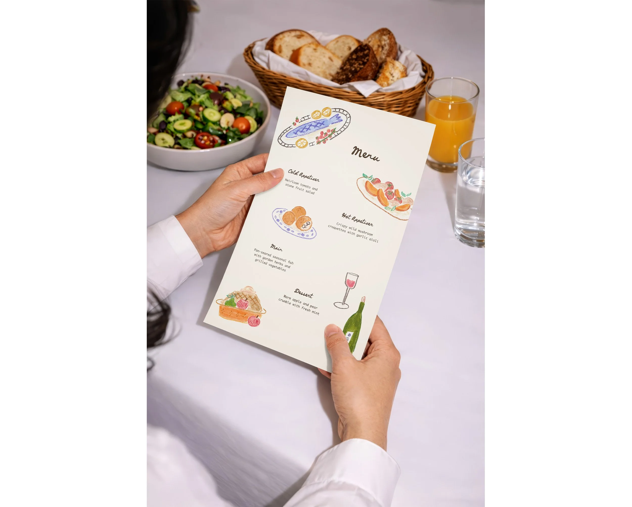 Woman holding an illustrated menu at a table with salad, bread basket, and glass of water.