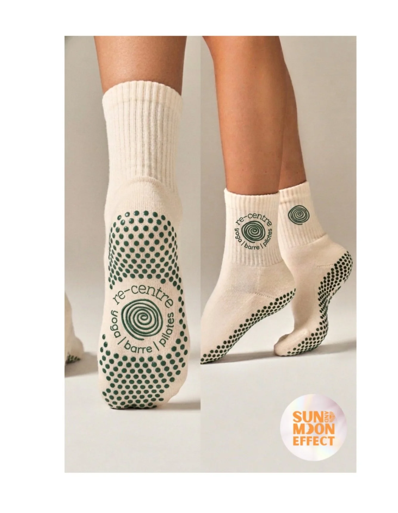 Close-up of person wearing white socks with black dot and swirl designs, standing on tiptoes on white surface. Socks have words 're-centre' and the brand logo on soles. Small round label with orange text reads 'SUN AND MOON EFFECT' at bottom right corner.