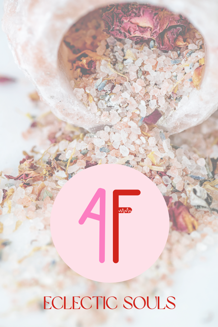 A pink circle with the Omega and Alpha symbols, with colorful salt and dried flower petals spilling out of a bag and the words "ECLECTIC SOULS" written beneath.