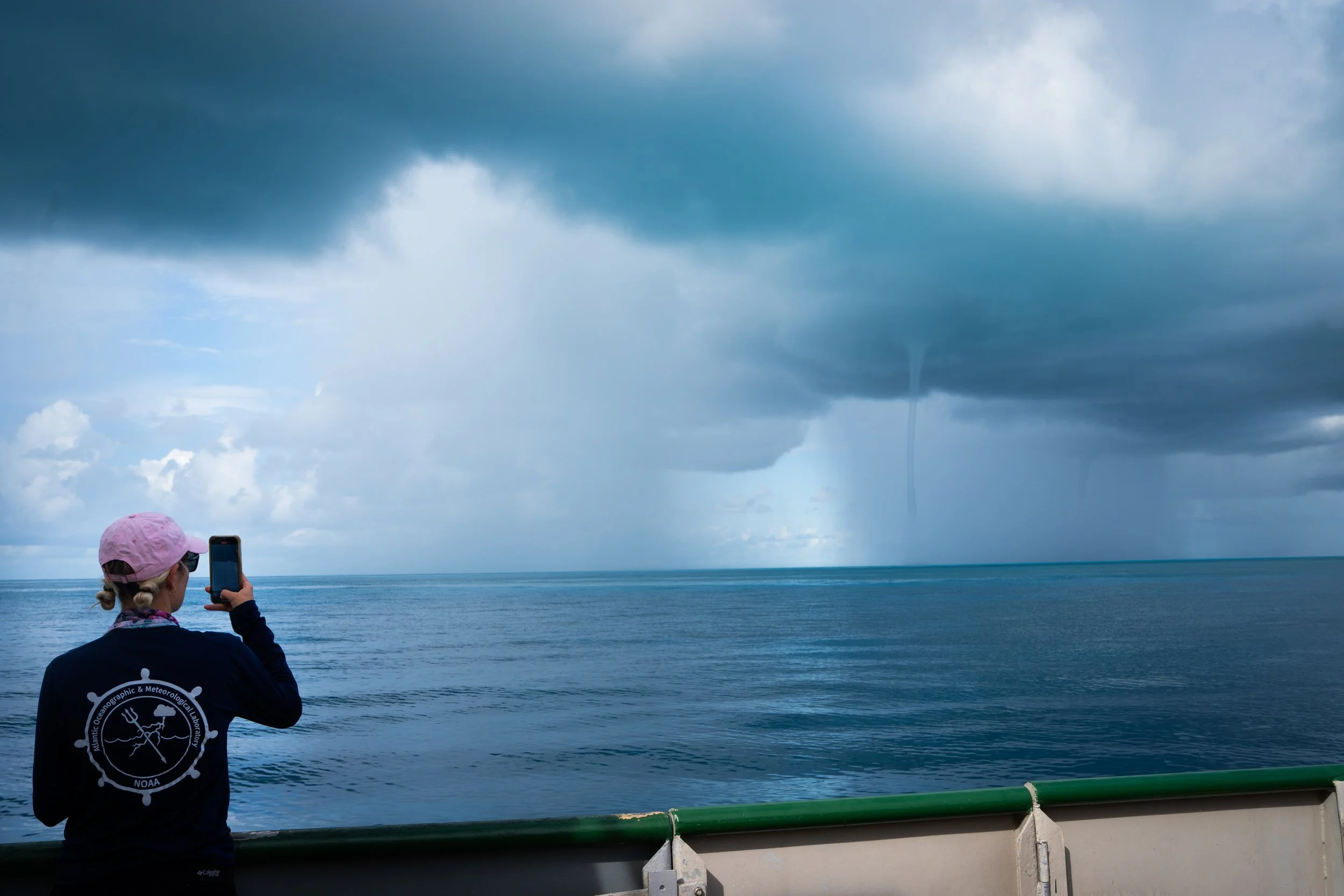 Tyler Christian photographs a waterspout during the research mission.