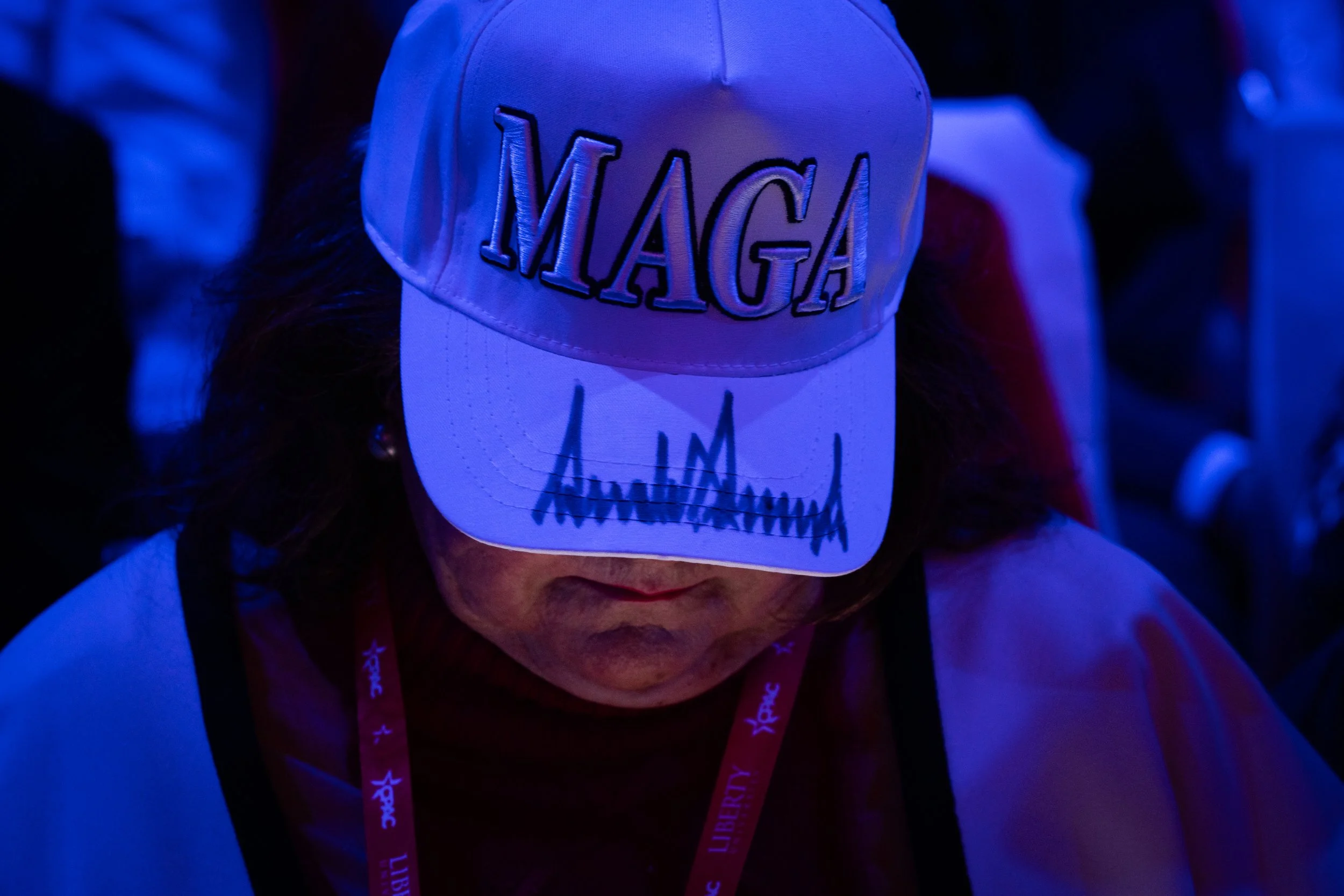 A woman wears a signed MAGA hat at the Conservative Political Action Conference (CPAC) conference on February 22, 2025 at the Gaylord National Resort & Convention Center in Oxon Hill, MD.