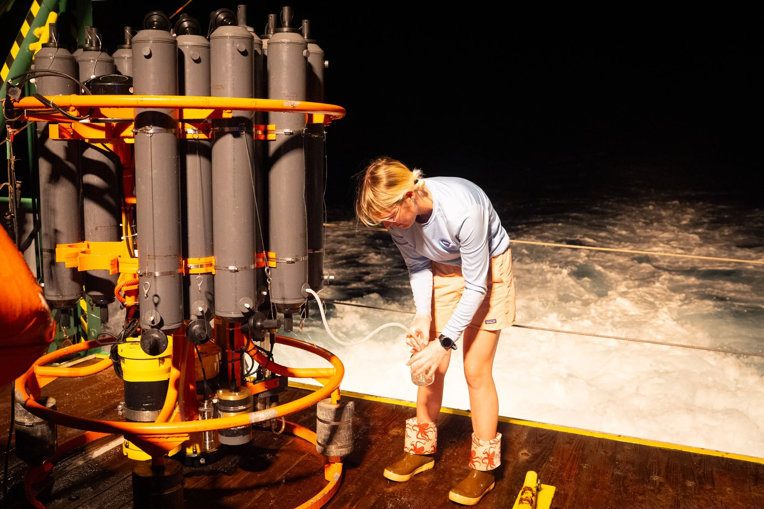 Tyler Christian, 26, a marine scientist and lab and field technician, collects ocean water from a recovered scientific instrument.