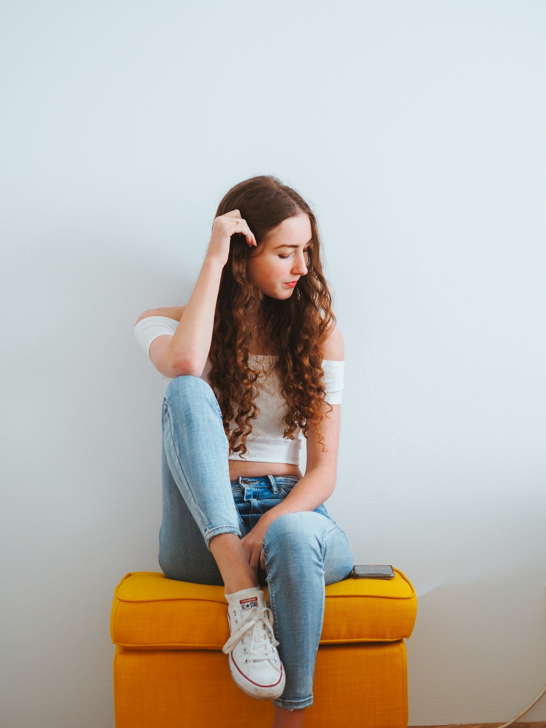 Teenager sitting on a stool