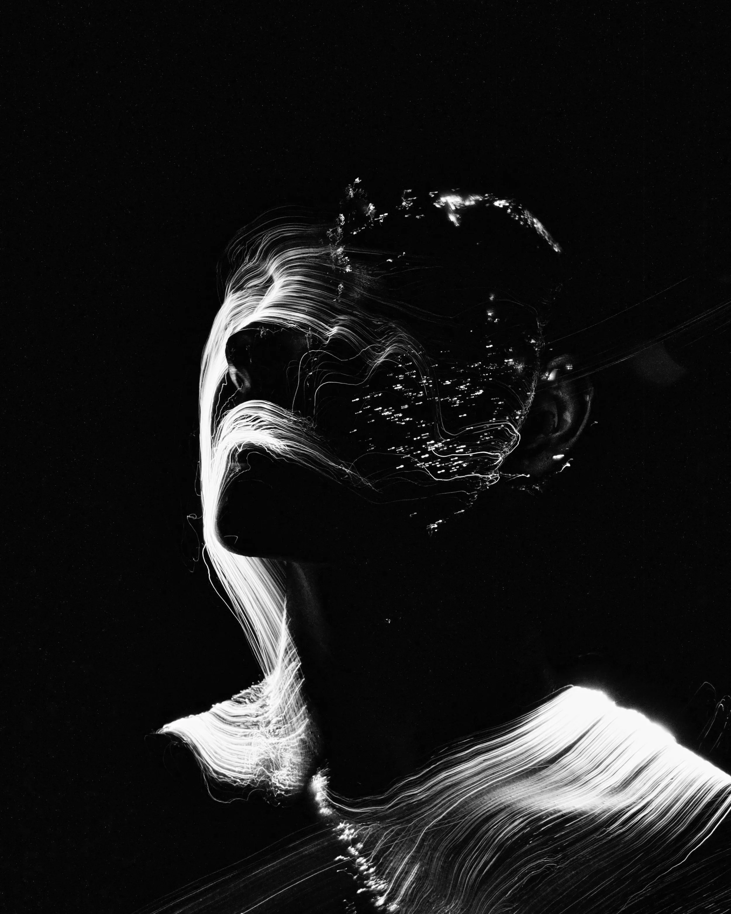 Black and white abstract portrait of a woman with light streaks creating a surreal effect.