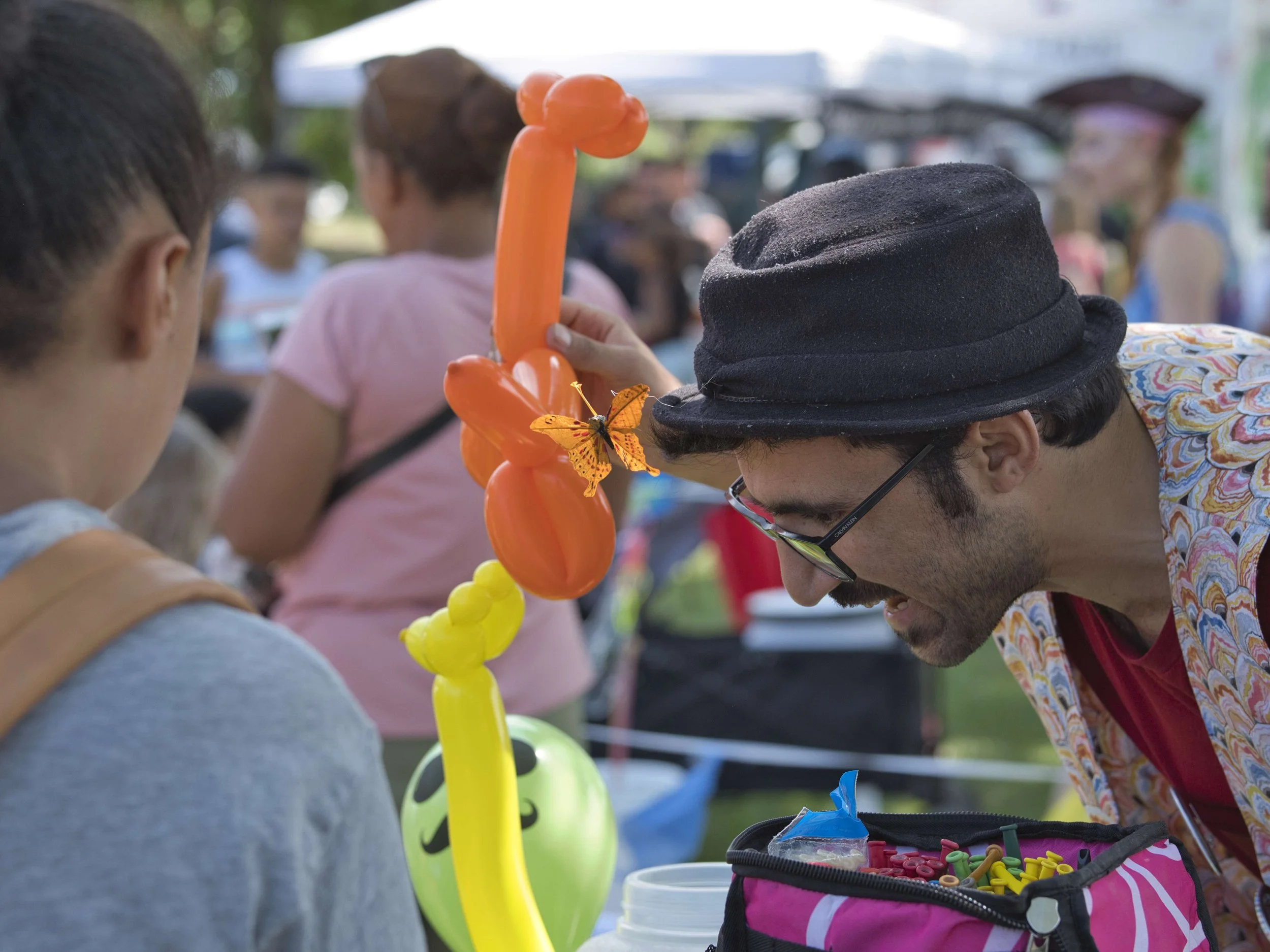 A balloon twister making balloon sculptures for kids