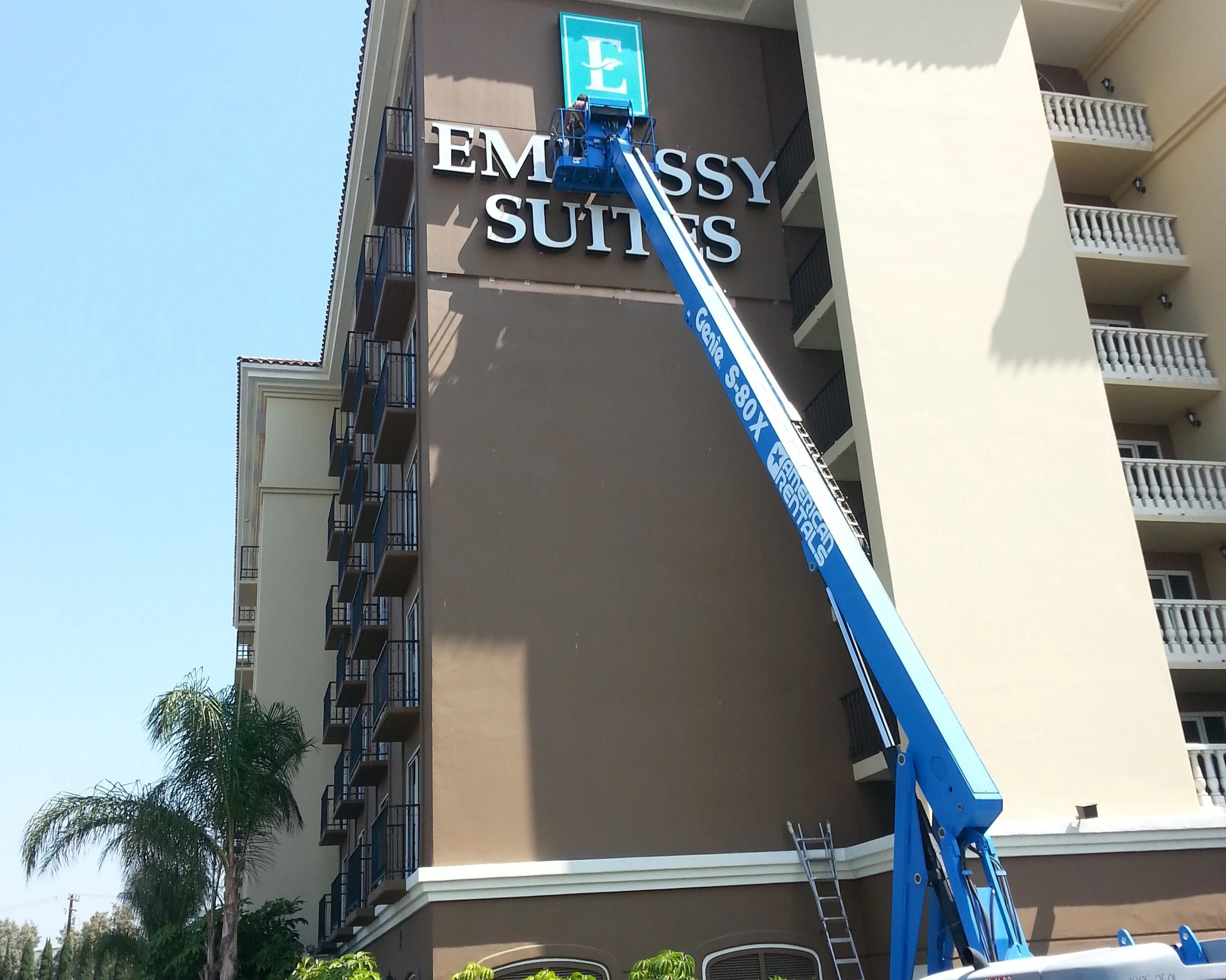 sign installation of hotel sign on the 6th floor with wall backer. high reach boom used for the installation in Los Angeles, ca.