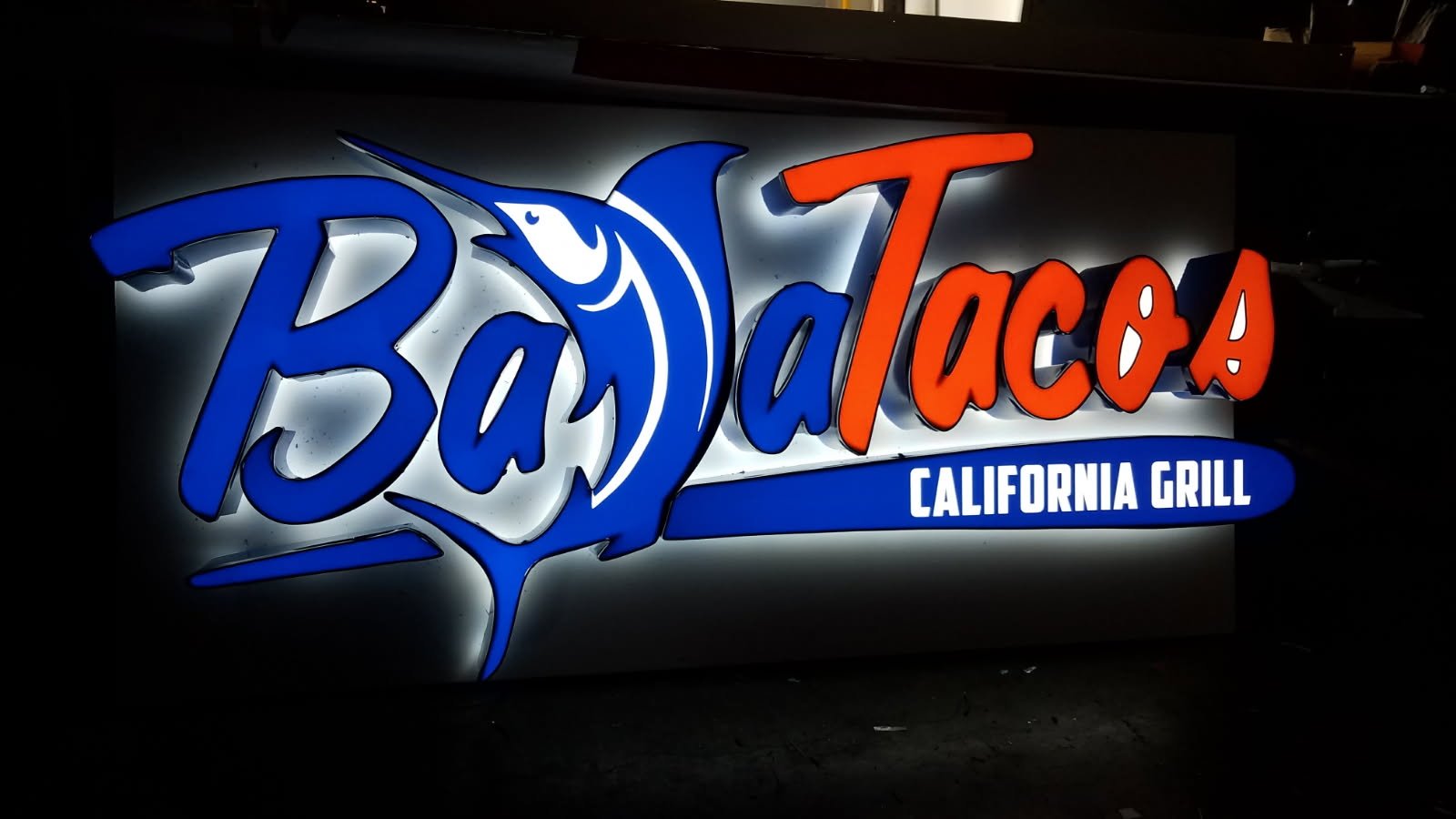 Channel letter sign on a restaurant/retail space night illuminated near Los Angeles, Ca.