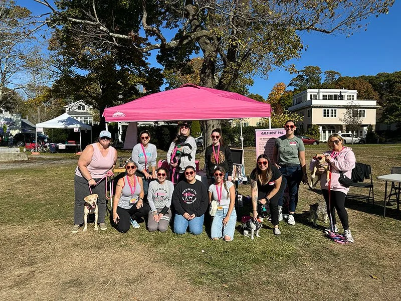 volunteers at an outdoor event under a tent