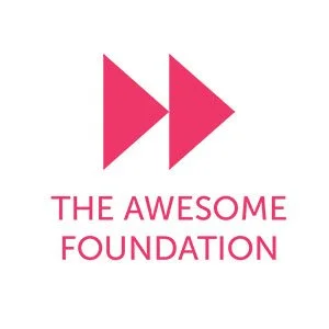 Logo with two pink arrows pointing right, above the text 'The Awesome Foundation' in pink.