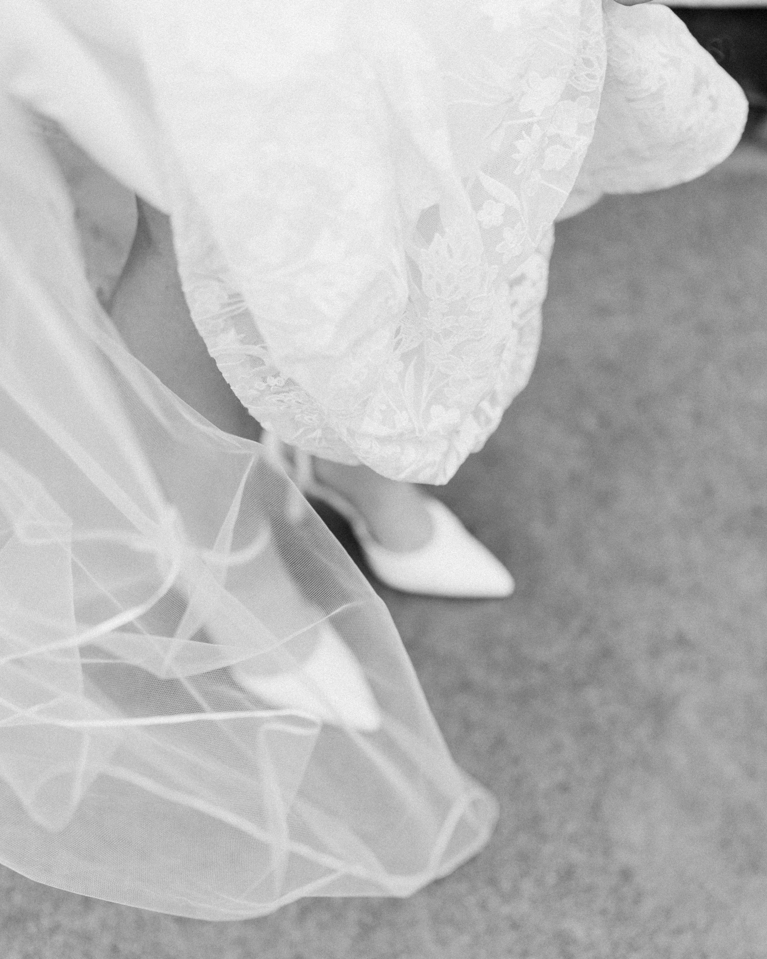 View of a bride's wedding dress, veil, and shoes from above.