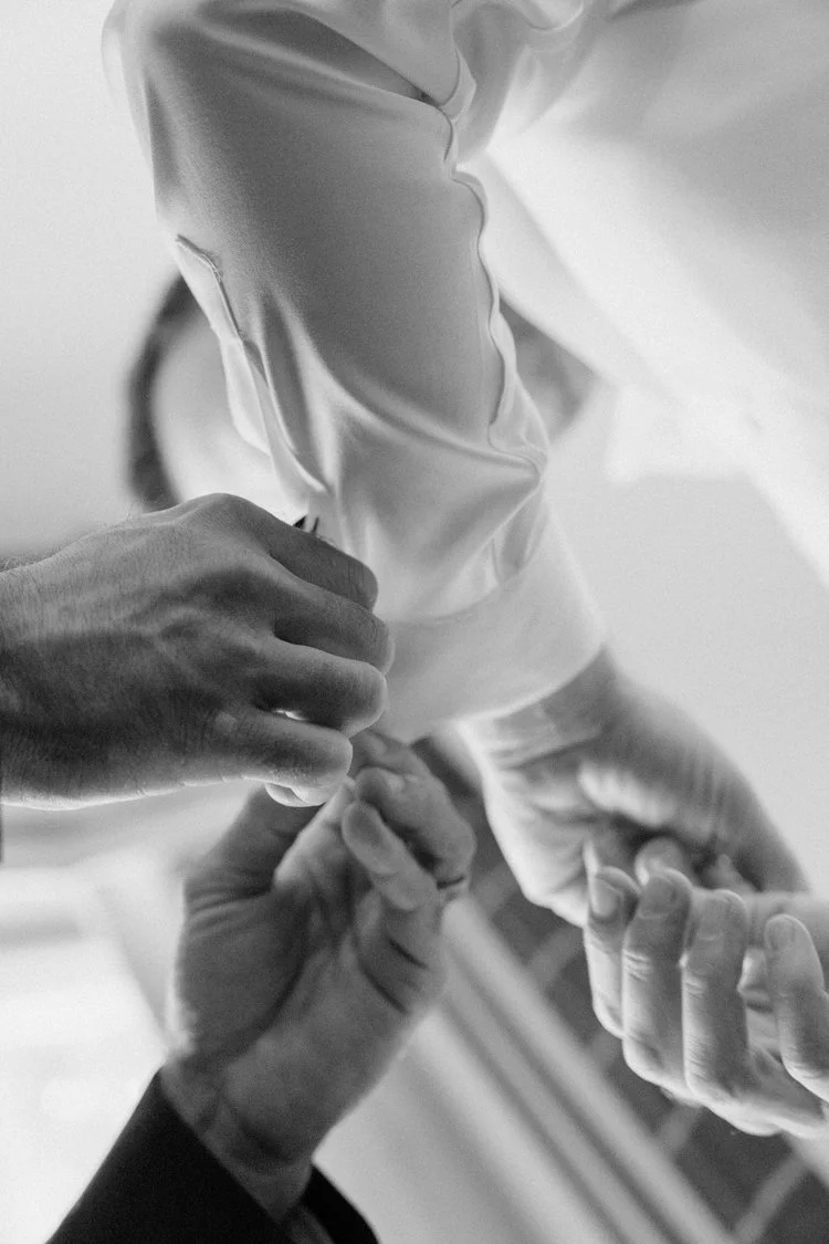 Two medical professionals in scrubs assisting with a medical procedure or examination.