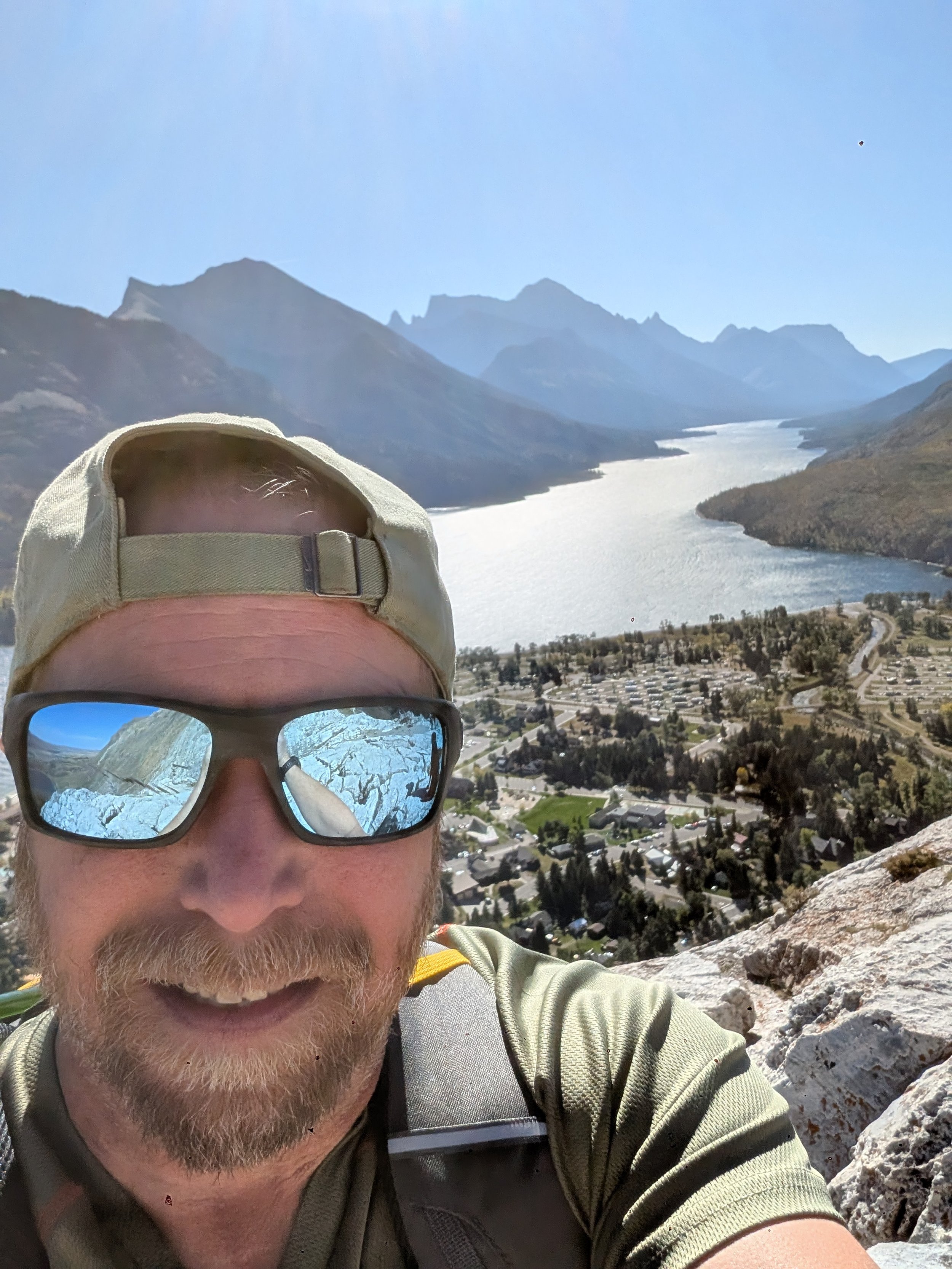 Our Founder, Michael Bugg on a hike in Waterton National Park. Here he overlooks the town-site that is below, which is Waterton Park and where he lives.