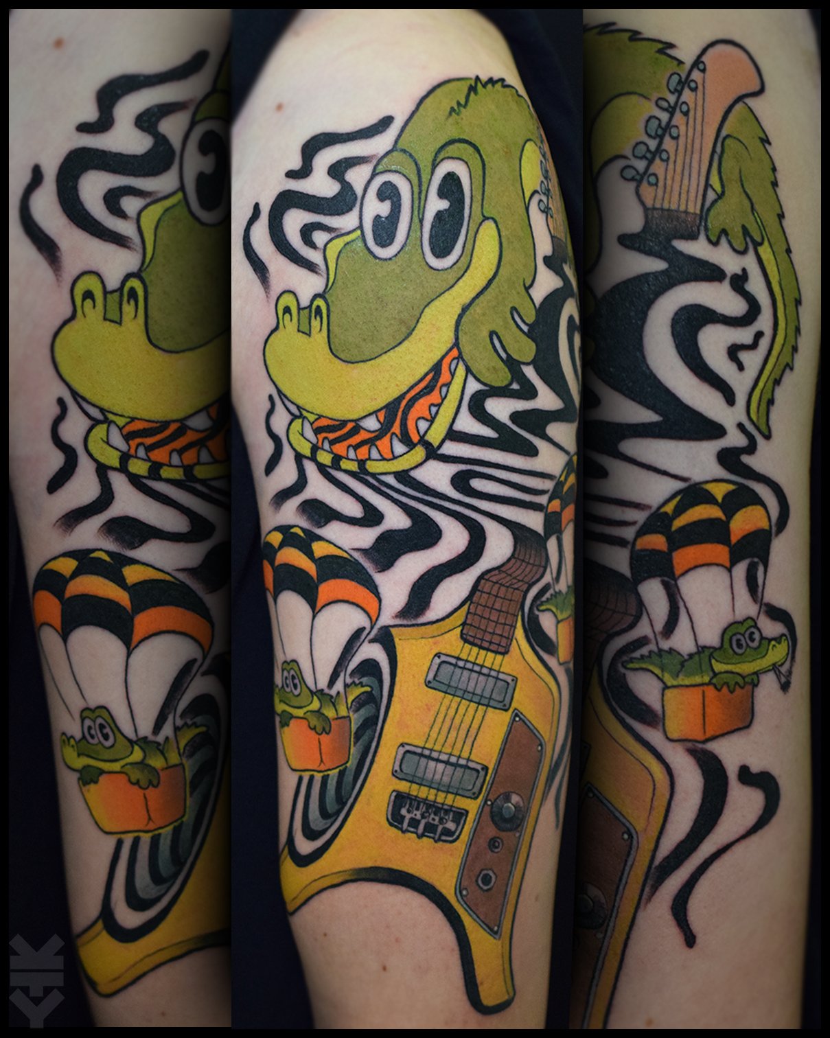 Tattoo of a cartoon crocodile with sunglasses, holding a yellow electric guitar, surrounded by black and white swirl patterns, with a small crocodile rides in a parachute basket and a guitar neck as part of the design.