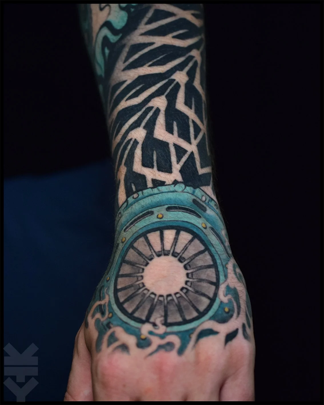 Tattooed arm with car tuning sleve design.