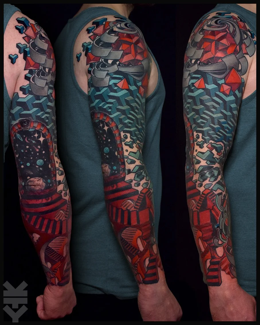 Colorful geometric tattoo sleeve featuring space-themed elements like planets and stars on a man's arm.