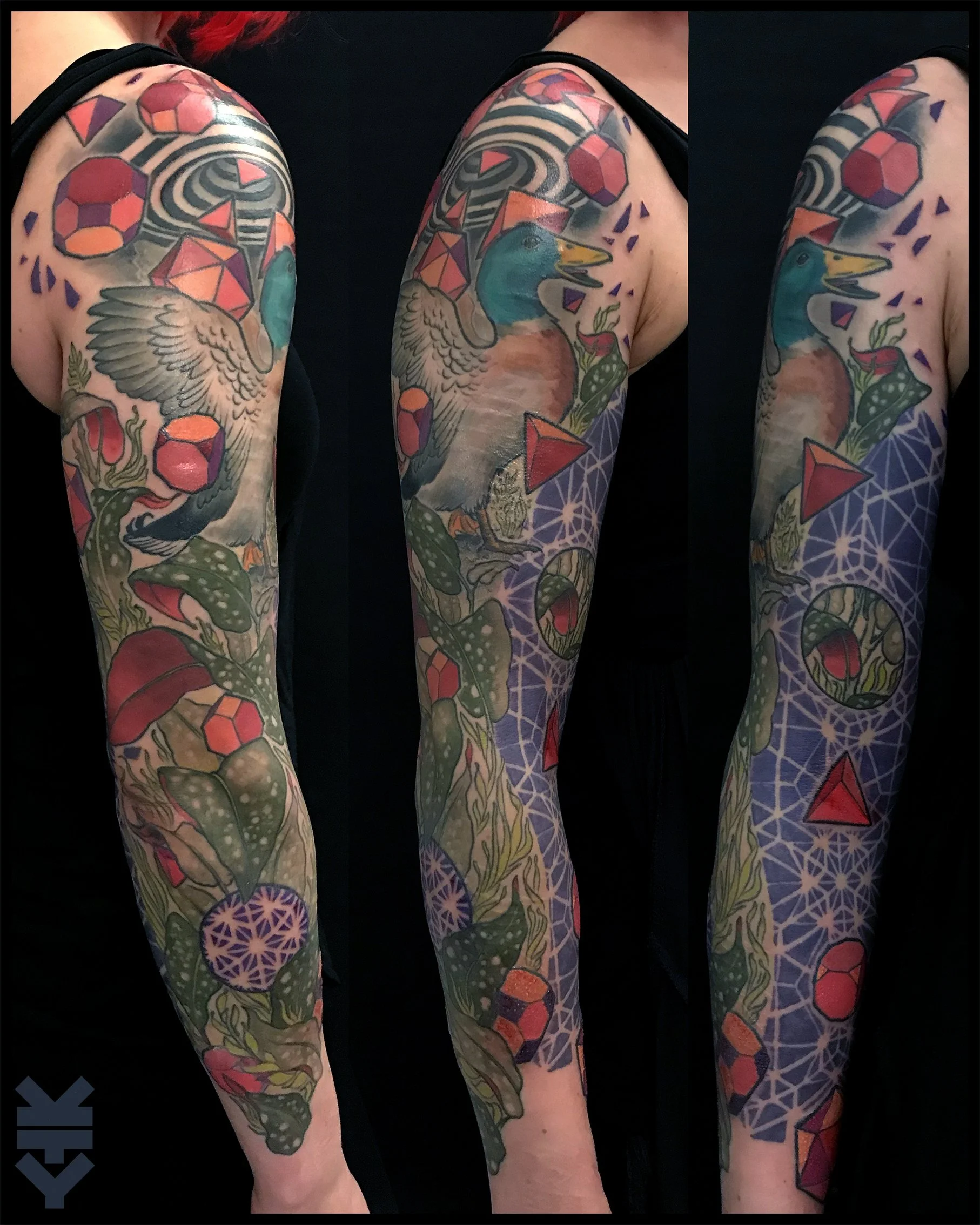 Colorful tattoo sleeve featuring a duck with geometric shapes and botanical elements.