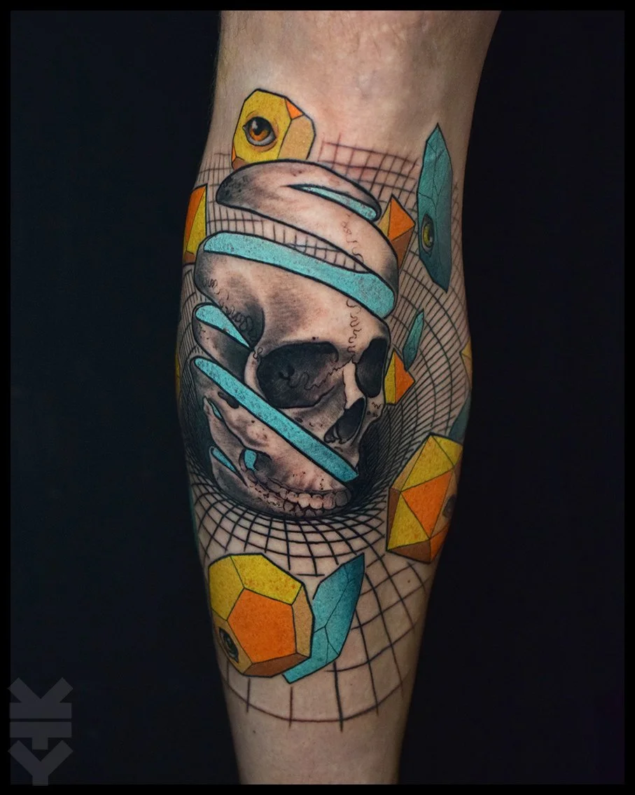 A tattoo of a human skull with geometric shapes and a grid background on a person's arm.