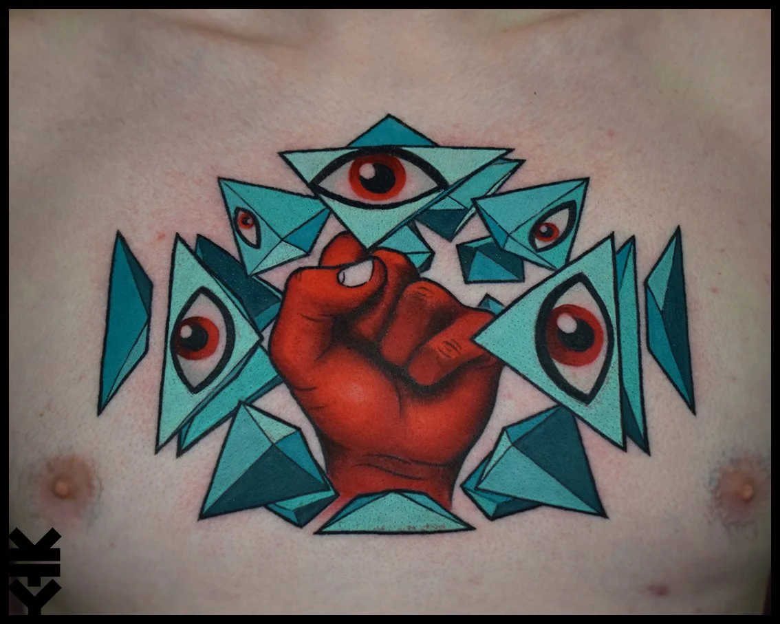 Tattoo of a clenched fist breaking through blue geometric glass with eye designs within the shards.