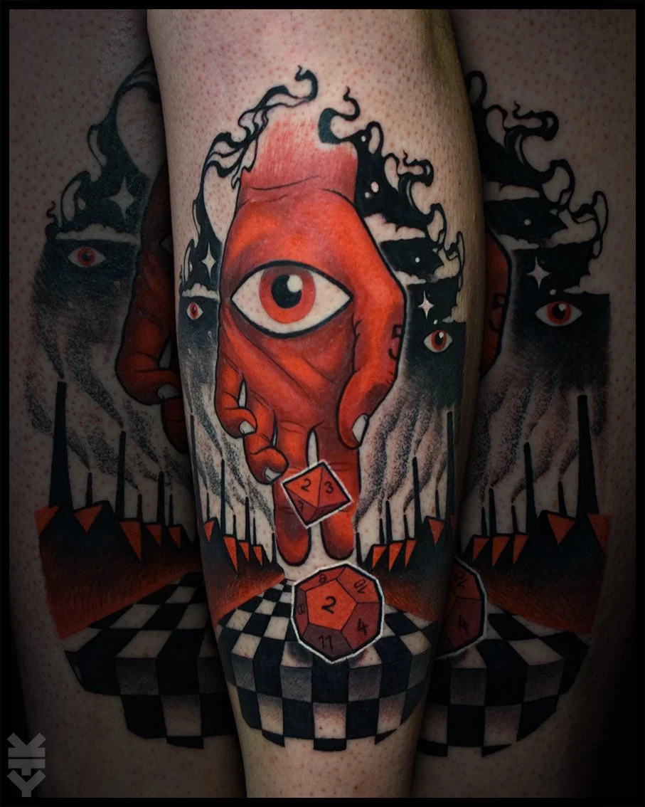 A tattoo featuring an eye on a red hand dropping dice, with a checkered floor and a dark background of spires and additional eyes.