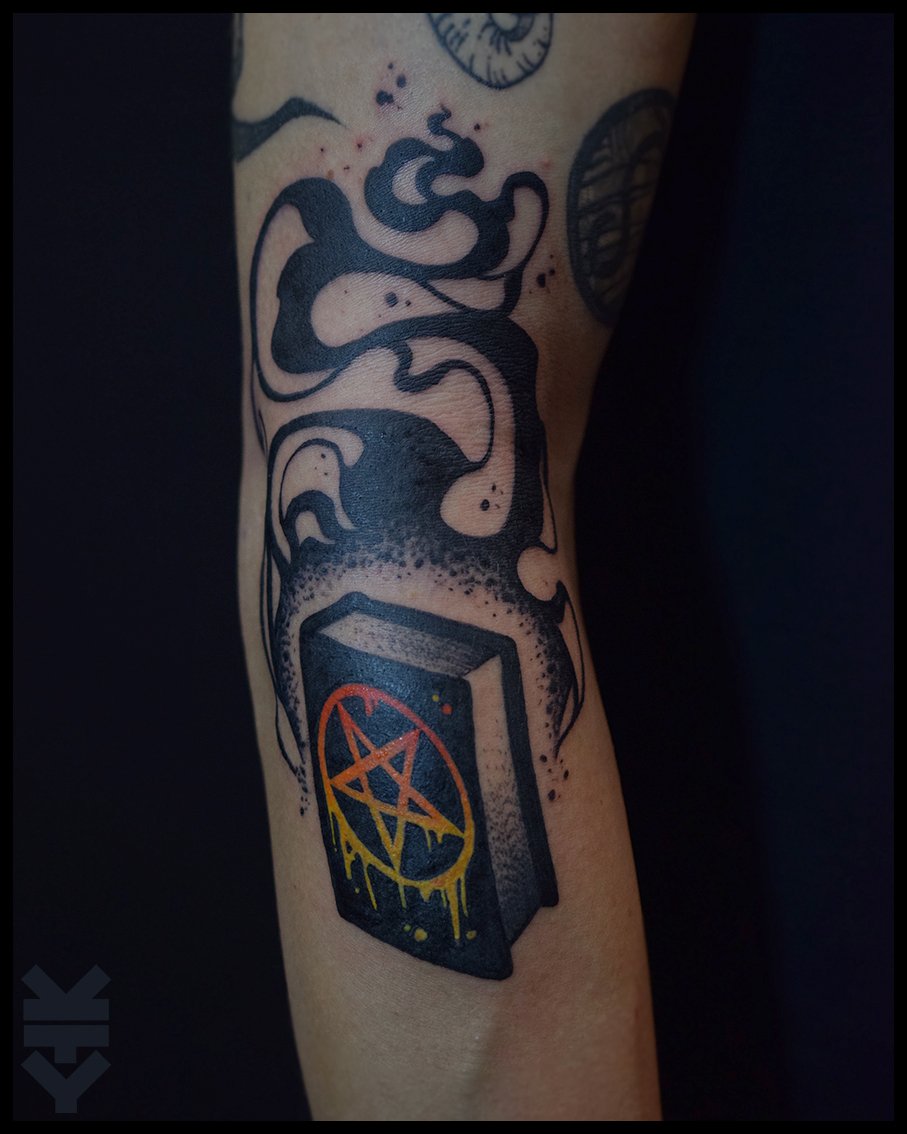 Tattoo of a speaker with a pentagram symbol, with smoke or vapor rising from it.