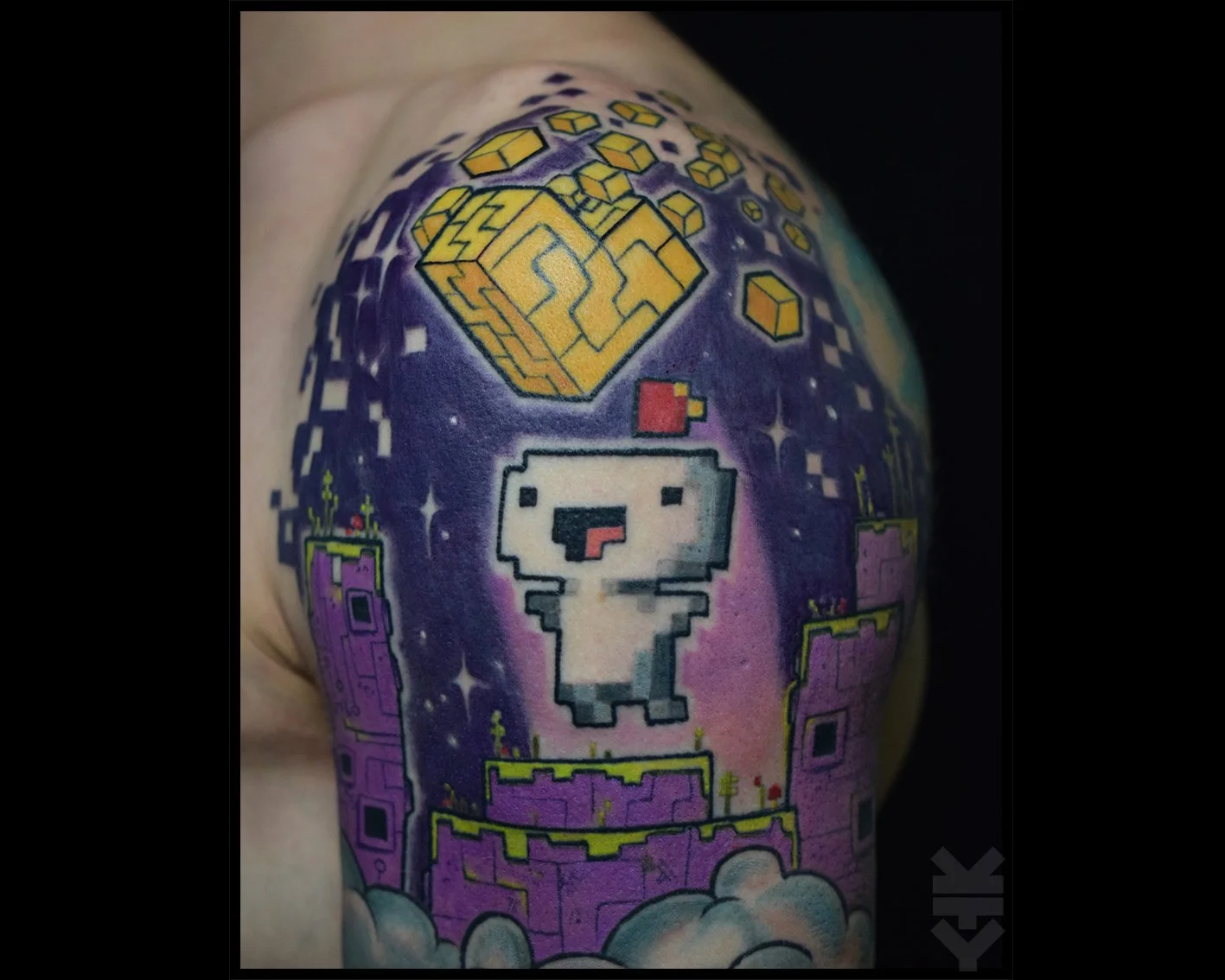 Colorful tattoo featuring a pixel art style character from the video game series Super Mario, with a white ghost wearing a red cap and a purple castle in the background, surrounded by yellow and purple geometric shapes and stars.